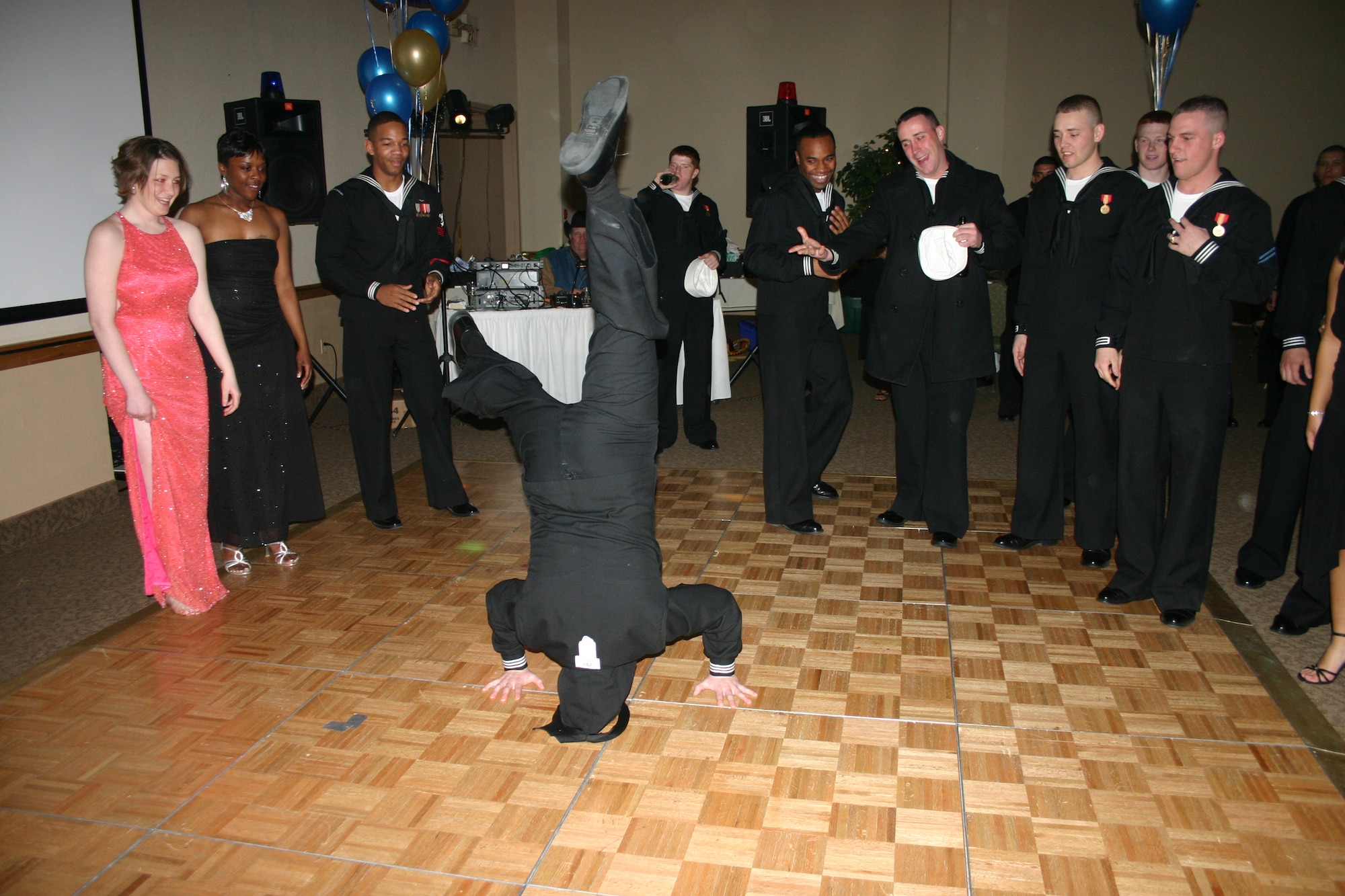 Seaman David Seek performs a headspin during the Seabee Ball at the Howard Johnson Plaza Hotel March 3. (U.S. Air Force photo/Staff Sgt. Tonnette Thompson)