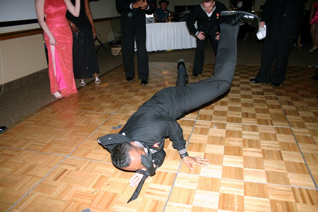 Seaman Jabarie Jones kicks off the dancing portion of the evening with breakdancing during the Seabees Ball at the Howard Johnson Plaza Hotel March 3.  (U.S. Air Force photo/Staff Sgt. Tonnette Thompson)