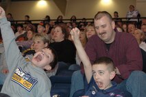 YOUNGSTOWN, Ohio — Air Force Reserve Staff Sgt. Bob Plant, a member of the 910th Airlift Wing Security Forces at the Youngstown Air Reserve Station, enjoys a night out with his son and a friend at the Chevrolet Centre downtown. Staff Sgt. Plant looks on as the boys react to a shot on goal by the Steelhounds, the Central Hockey League affiliate team here. They were attending the game as part of a Stars & Stripes Night promotion, honoring area uniformed services, sponsored by the team. The Steelhounds were facing a division rival, the Memphis Riverkings. The 'Hounds went on to win the game with a score of 4-1. U.S. Air Force Photo/Tech. Sgt. Bob Barko Jr.