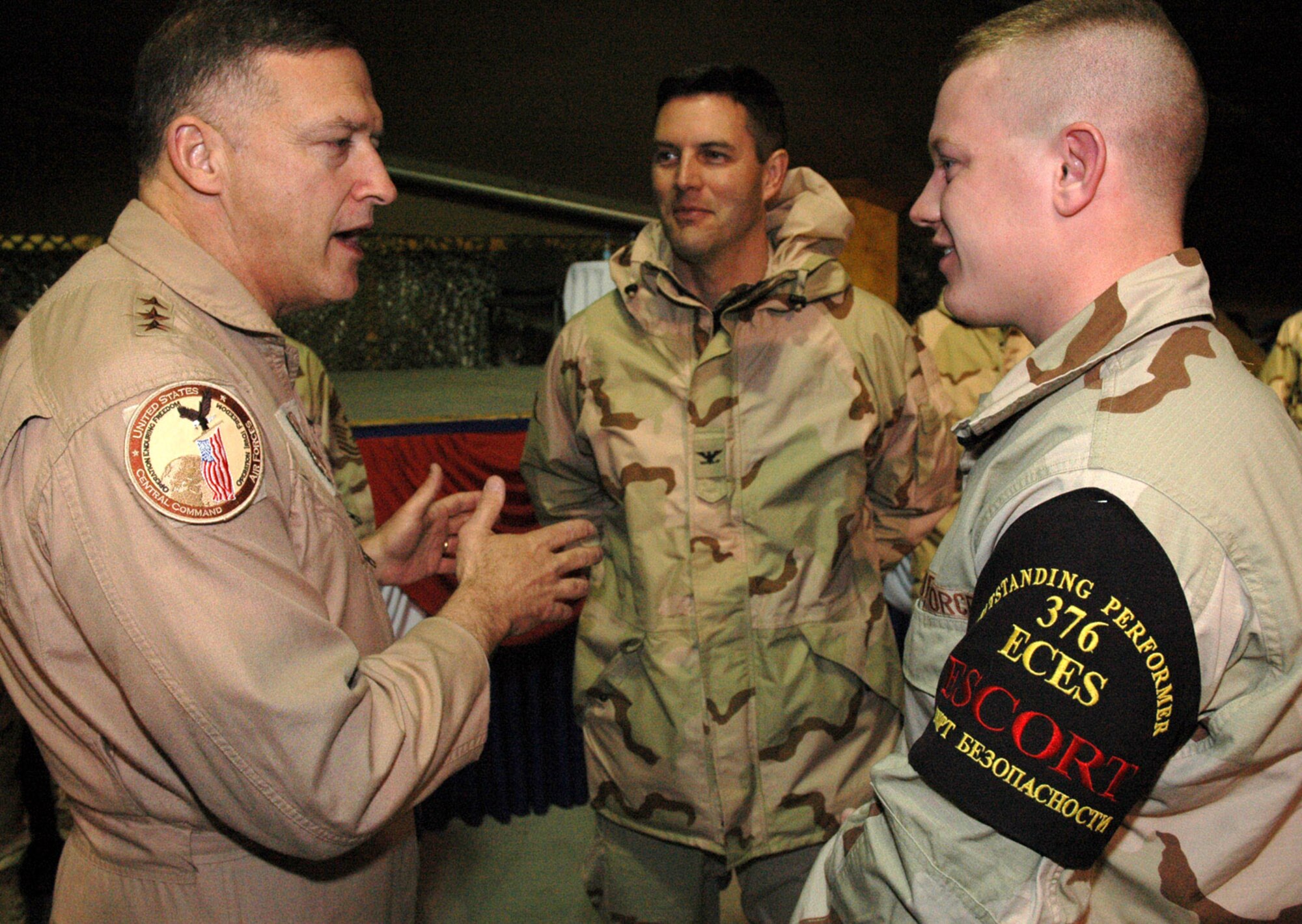 Lt. Gen. Gary North thanks Airman 1st Class Anthony Corman for his contributions as a host-country-national escort at Manas Air Base, Kyrgyzstan. Airman Corman is deployed to the 376th Air Expeditionary Wing from the 436th Maintenance Squadron at Dover Air Force Base, Del. General North is the commander of 9th Air Force and U.S. Central Command Air Forces at Shaw Air Force Base, S.C. (U.S. Air Force photo/Master Sgt. Daniel Nathaniel)