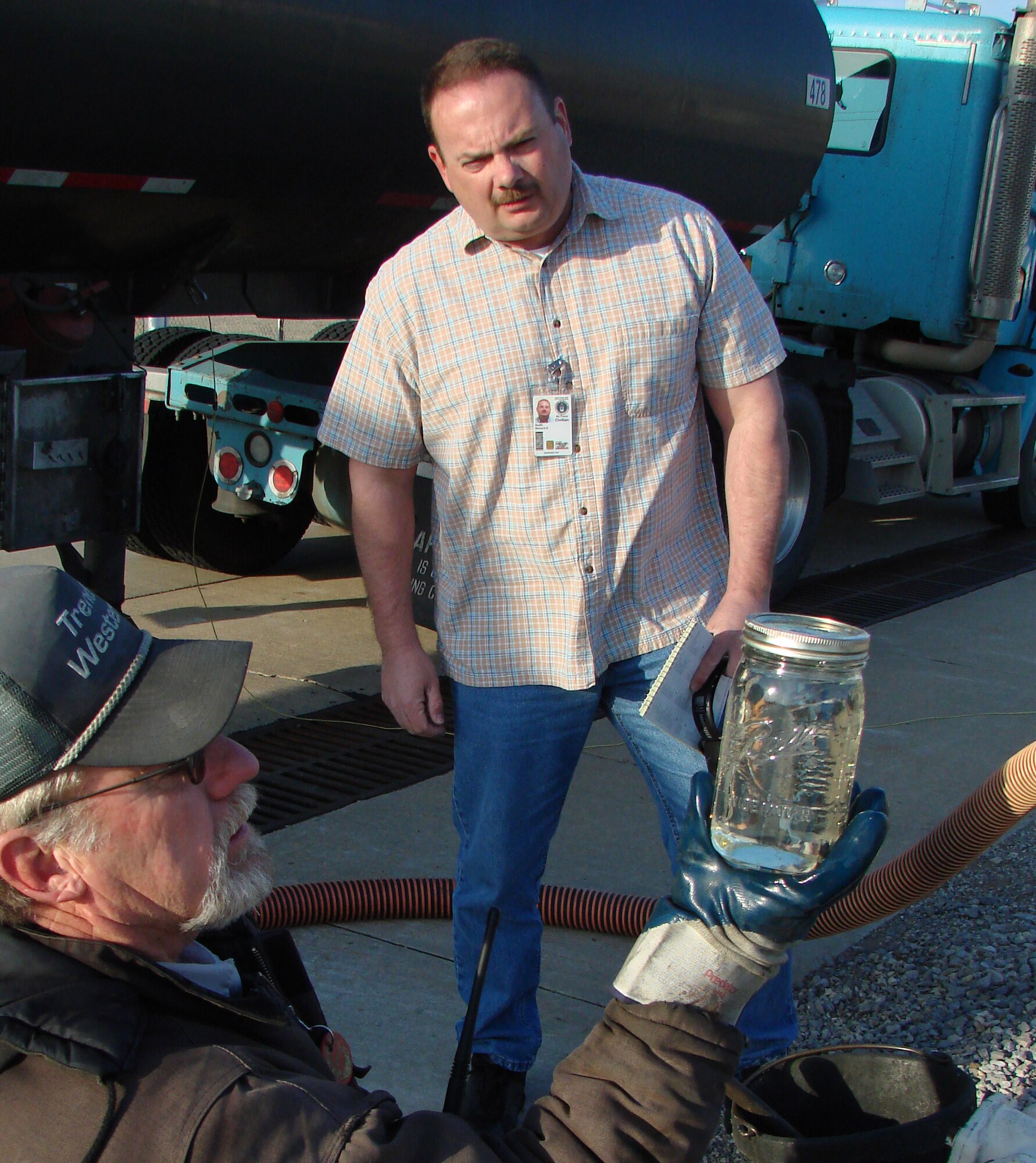 VANCE AIR FORCE BASE, Okla. -- Richard Smith, a quality assurance evaluator for the Vance AFB fuel contract, oversees Allan Bray, Trend Western fuel storage attendant, obtain a visual fuel sample during a tank truck receipt March 7. Mr. Smith was recently named the Air Education and Training Command's 2006 Fuels Civilian Leader of the Year. (U.S. Air Force Photo by Tech. Sgt. Mary Davis)                               