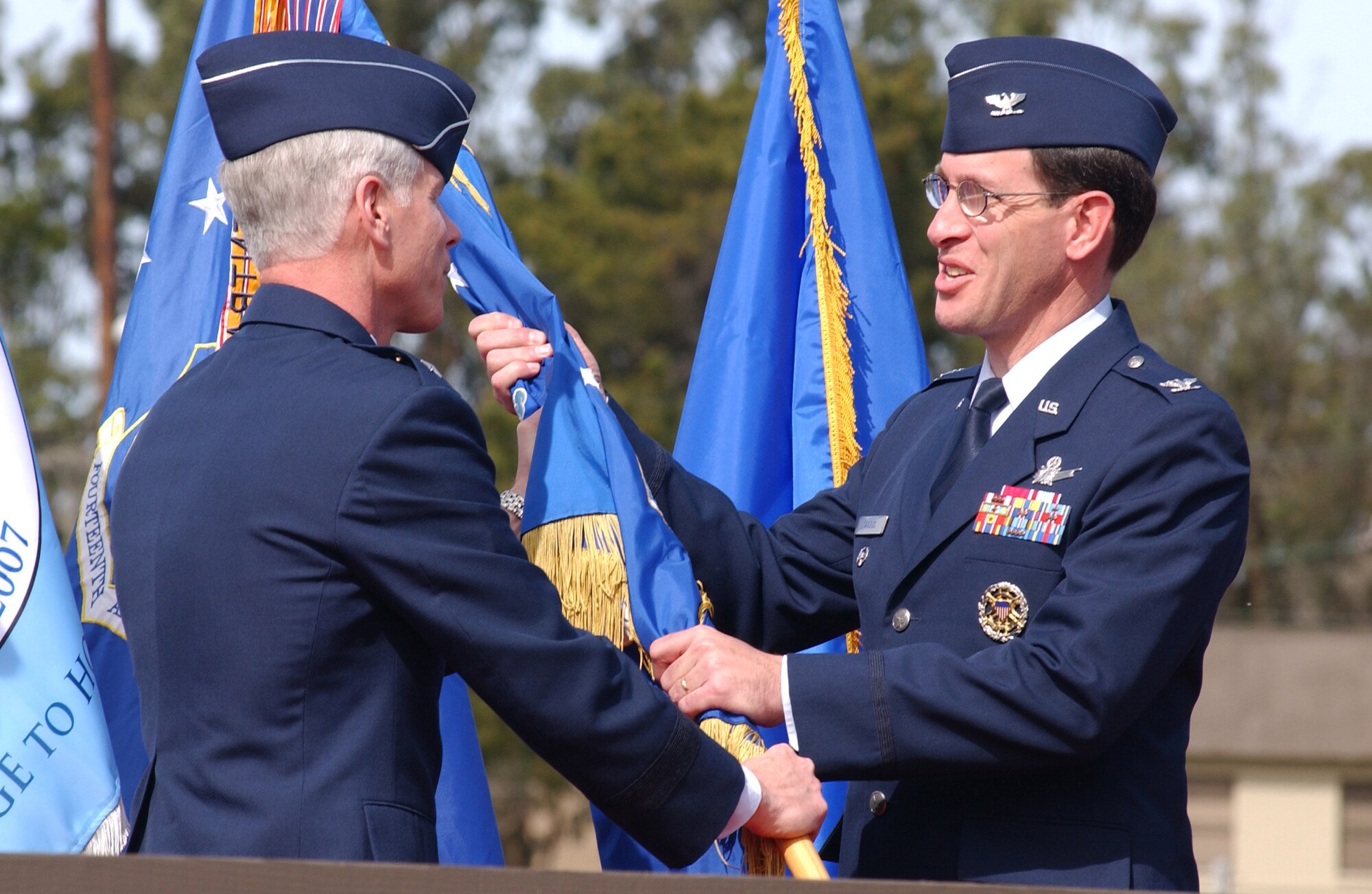 Col. Stephen Tanous (right) receives command of the 30th Space Wing from Maj. Gen. William Shelton, 14th Air Force commander.