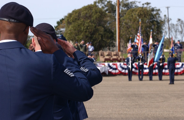 Members of the 30th Space Wing salute the colors during the 30th Space Wing change of command at Vandenberg on March 5.  The change of command signifies a change in base commander for the next two years. (U.S. Air Force photo by Airman Adam Guy)