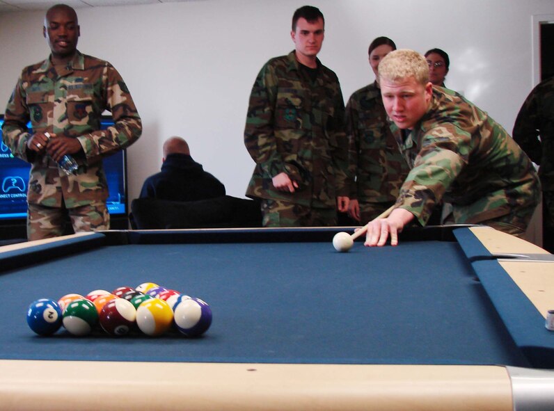 Airman 1st Class Tanner Holcomb, an Air Traffic Controller in the 71 OSS, begins the first game of pool at Monty's.  Monty's, the Airmen Center, provides enlisted personnel with a safe environment for recreation including pool, video games, and big screen TVs.  (U.S. Air Force photo/2nd Lt. James Justice)