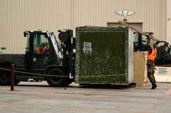 Airman 1st Class Ronald Stafford and Staff Sgt. Ryan Moyer, both of the 437th Aerial Port Squadron, move a weapons case on the flightline during the exercise.(RELEASED)(U.S. Air Force Photo by Airman 1st Class Nicholas Pilch)
