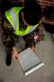 1st Lt. Deanna Minor, 437th Aerial Port Squadron Air Fright Flight commander, checks cargo paperwork during the Mobility Exercise March 1.(RELEASED)(U.S. Air Force Photo by Airman 1st Class Nicholas Pilch)
