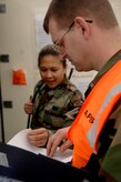 Staff Sgt. Desiree Yago, 437 Logistics Readiness Squadron, goes over a moblility checklist with Staff Sgt. Ryan Moyer, 437th Aerial Port Squadron.(RELEASED)(U.S. Air Force Photo by Airman 1st Class Nicholas Pilch)