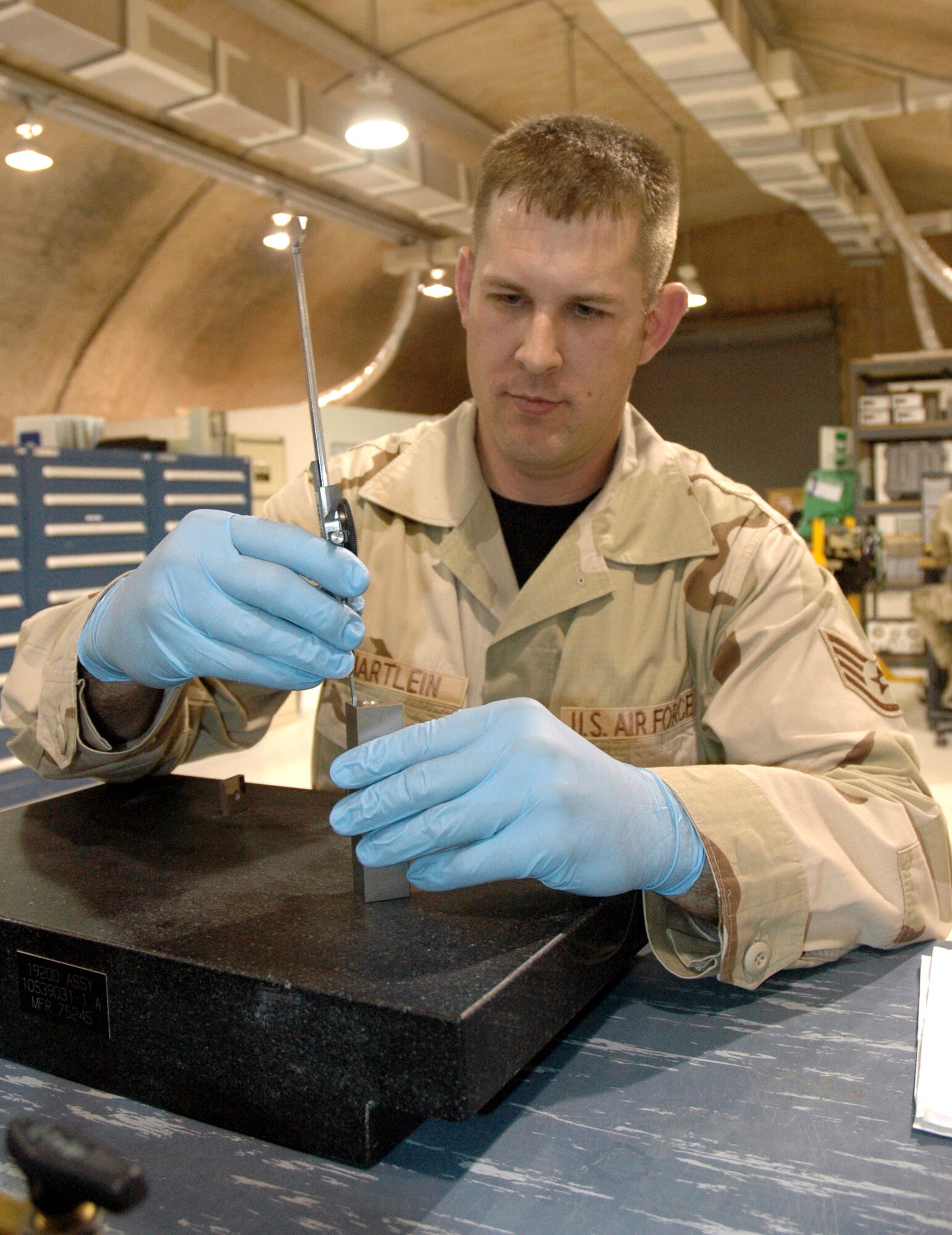 Staff Sgt. Jeffrey Hartlein, 379th Expeditionary Maintenance Squadron Test, Measurement, and Diagnostic Equipment Flight TMDE craftsman, calibrates a dial caliper used to make length or width measurements on a multitude of different parts. (U.S. Air Force photo/Senior Airman Erik Hofmeyer) 

