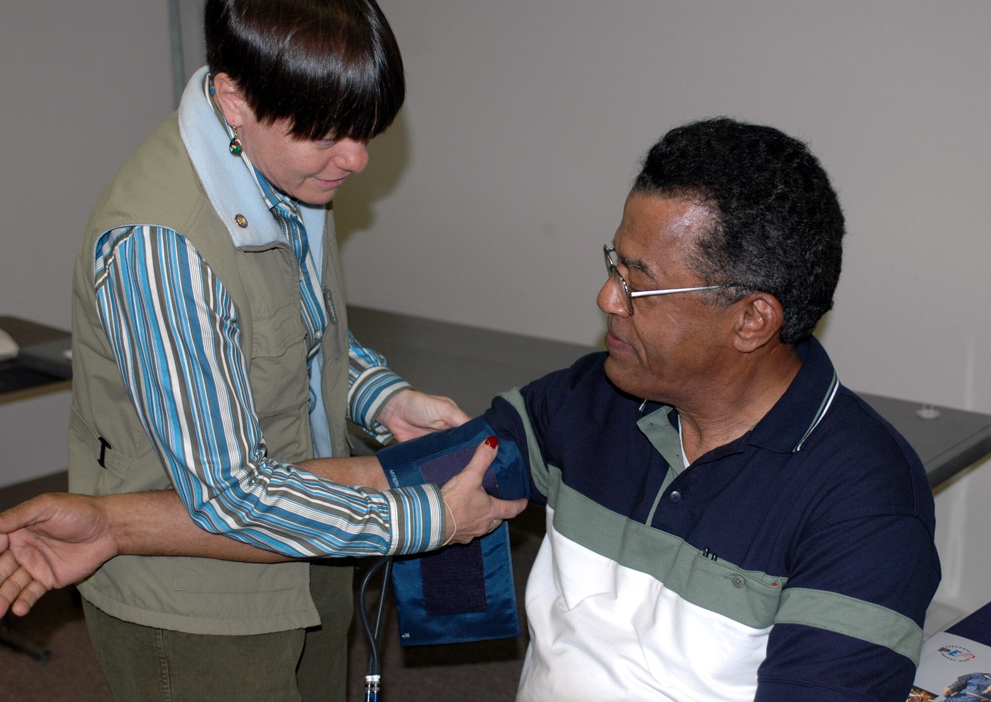 Dr. Mary Nelson, Health and Wellness Center director, prepares to check Chief Master Sgt. (retired) Kermit Allen's blood pressure during Retiree Appreciation Day at the Travis Conference Center March 3. Approximately 300 retirees attended the event, designed to honor and thank the men and women who live in the local community who previously served in the military. The event included free medical screenings and a tour of a C-17 Globemaster III. Team Travis would like to thank Mr. Joe Rowan, Chief Master Sgt. George Moses, Capt. James Kerley and Capt. Christina Howlett for their hard work organizing the event. (U.S. Air Force photo by Staff Sgt. Candy Knight)