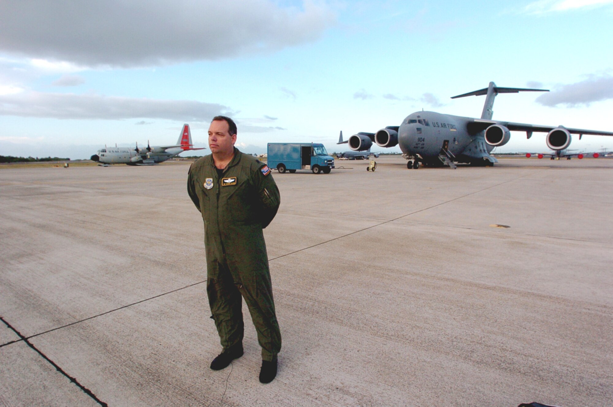 Lt. Col. Jim McGann stands on the Hickam flightline in front of a C-17 Globemaster III from McChord Air Force Base, Wash., and an LC-130 Hercules from the 109th Airlift Wing at Scotia, New York. The 2006-2007 season of the 13th Air Force-led Joint Task Force-Support Forces Antarctica, Operation Deep Freeze, wrapped up Feb. 26 with the redeployment of the aircraft from Christchurch, New Zealand. This unique joint and total force mission has supported the National Science Foundation and U.S. Antarctic Program since 1955. (U.S. Air Force photo) 
