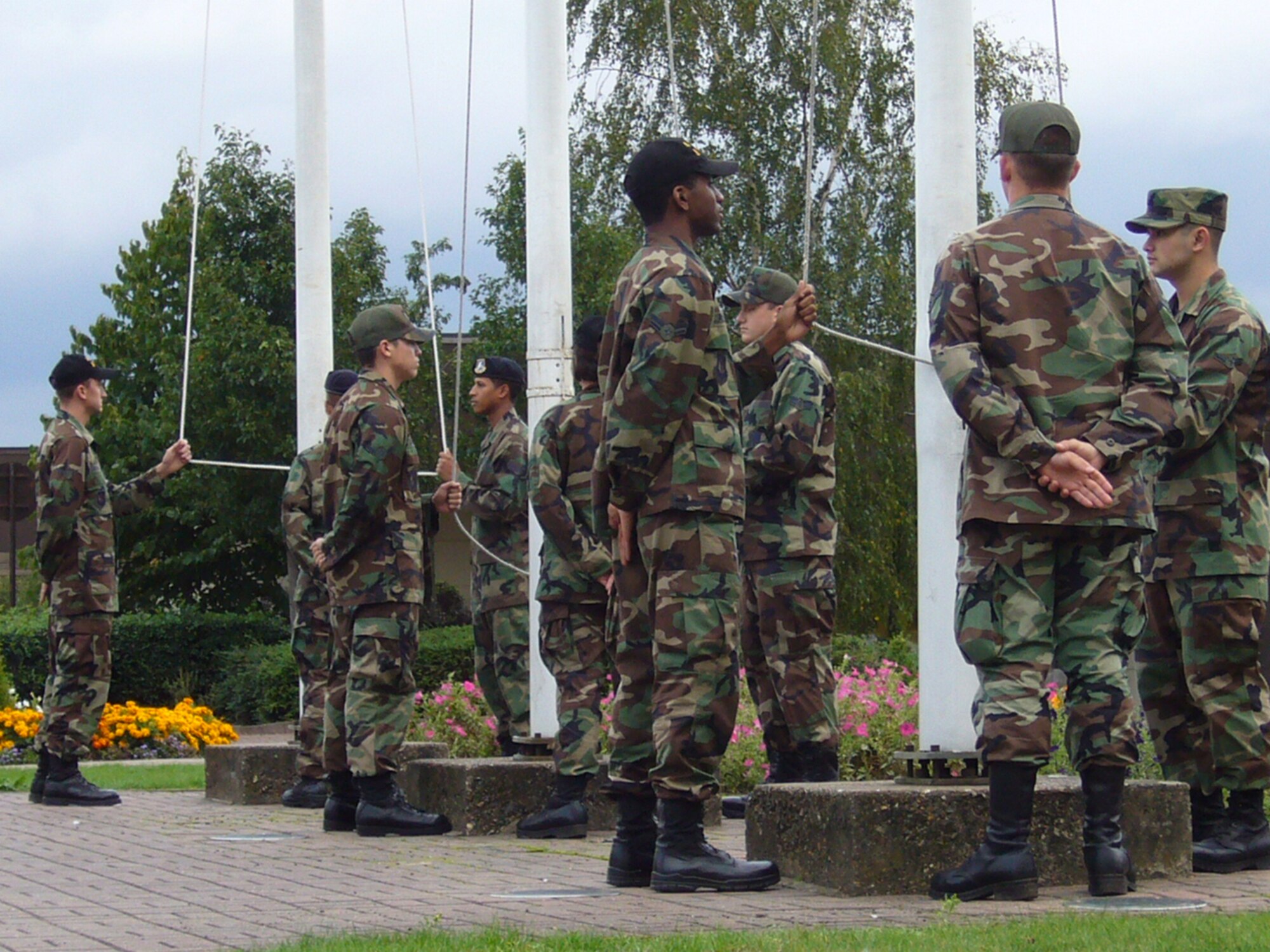 First Term Airmens Center class 06-36 prepares to lower the flags during RAF Lakenheath's retreat ceremony. FTAC is responsible for raising and lowering the US flag, British flag and POW/MIA flag almost every day. (US Air Force photo by Staff Sgt. Shannalee Karrick)