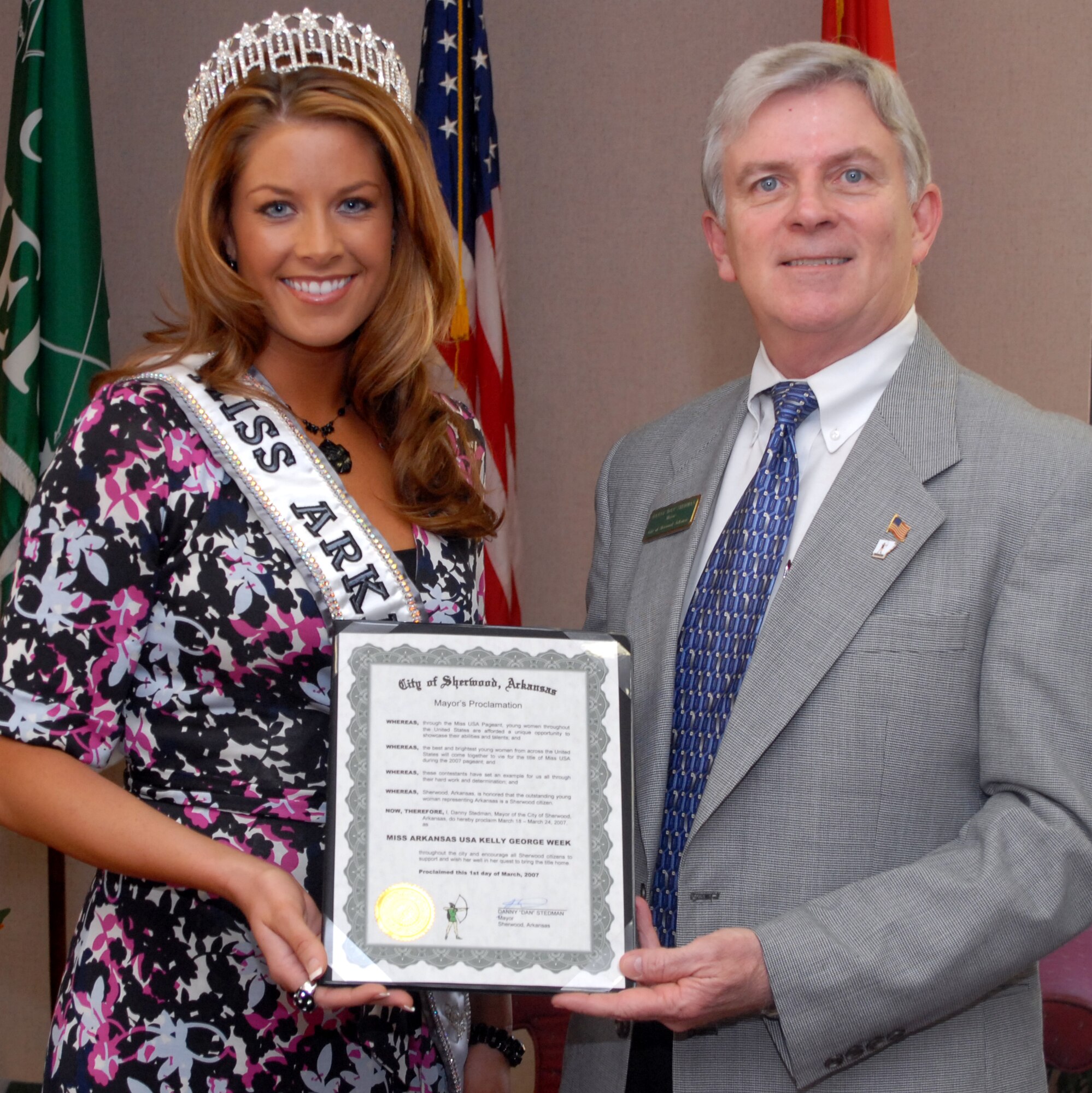 Sherwood Mayor Dan Stedman presents Second Lt. Kelly George, Miss Arkansas USA, a proclamation declaring March 19-24 as "Miss Arkansas USA Kelly George Week" March 1. During her send-off event the evening March 1, Lieutenant George was presented with a key to the city of Sherwood by Mayor Stedman. 
"We are so proud of her and to have her live in Sherwood. She will do great representing Arkansas and our Armed Forces," said Mayor Stedman, a retired Air Force lieutenant colonel. "We wish her well and hope she brings the title home to Arkansas."