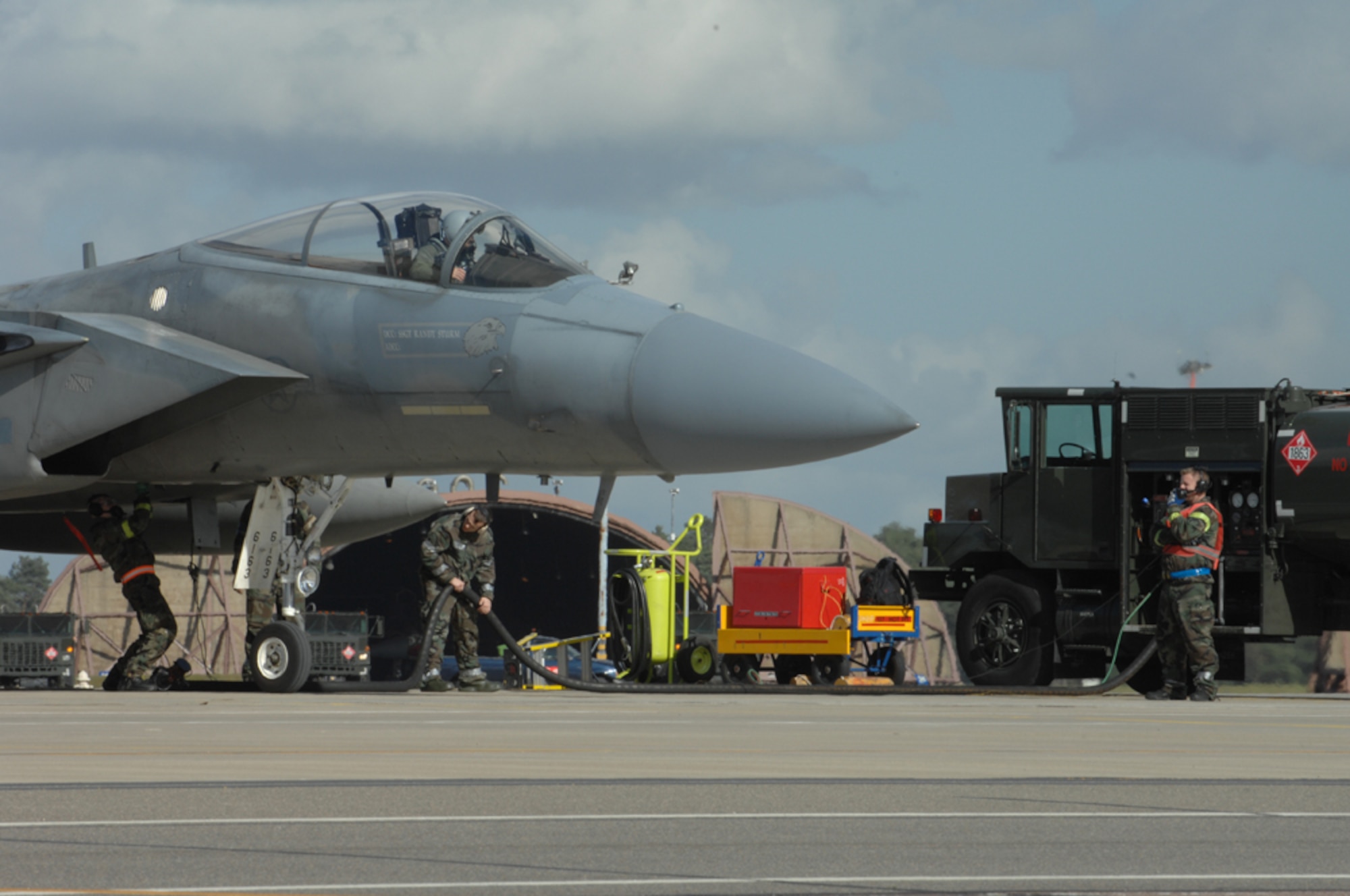 U.S. Air Force Airmen from the 48th Logistics Readiness Squadron, Petroleum Oils and Lubricants flight perform a hot pit refueling on an F-15C Eagle during a Phase 2 exercise here March 6. (US Air Force photo by Airman John Easterling)