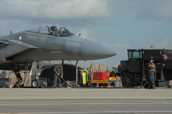 U.S. Air Force Airmen from the 48th Logistics Readiness Squadron, Petroleum Oils and Lubricants flight perform a hot pit refueling on an F-15C Eagle during a Phase 2 exercise here March 6. (US Air Force photo by Airman John Easterling)