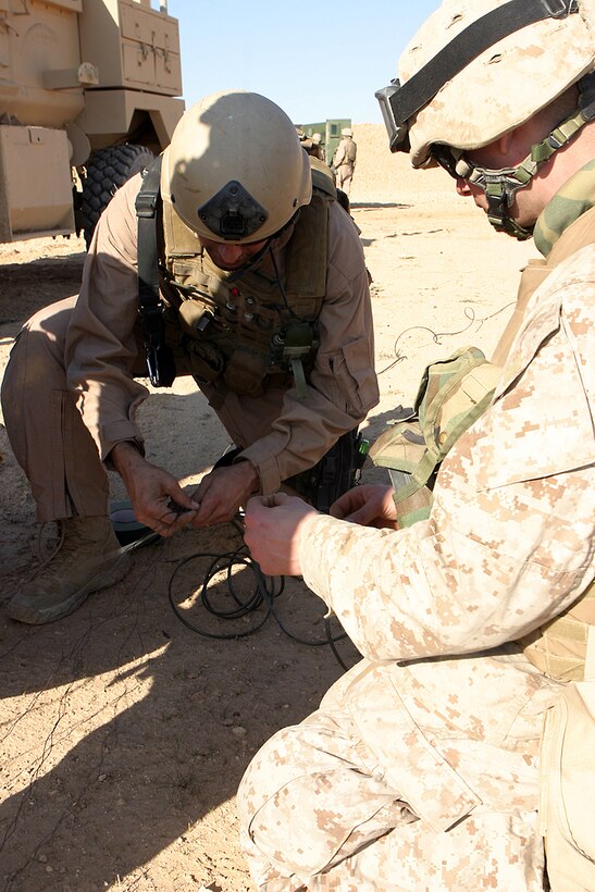 U.S. Marine Corps Gunnery Sgt Aaron Salyi (left), explosive ordnance disposal cheif from Combat Logistics Battalion attached to Battalion Landing Team 2/4, demonstrates to Marines the proper way to prepare ordnance for disposal, Feb. 22, 2007.
