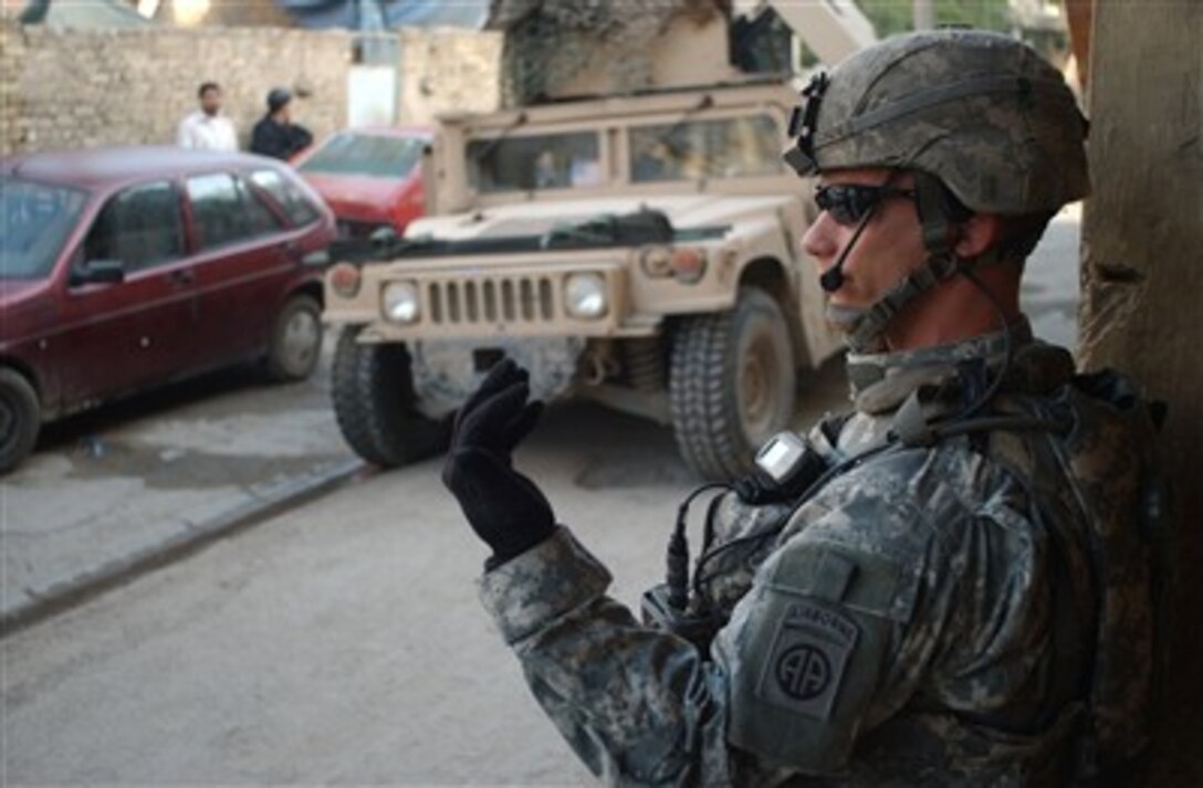 U.S. Army Staff Sgt. Brandon Cady motions his soldiers to come forward during a combined mission with Iraqi army soldiers from 1st Battalion, 3rd Brigade, 4th Division in Kadhamiya, Iraq, on Feb. 28, 2007.  Cady is assigned to Bravo Company, 1st Battalion, 325th Airborne Infantry Regiment, 2nd Brigade Combat Team, 82nd Airborne Division.  