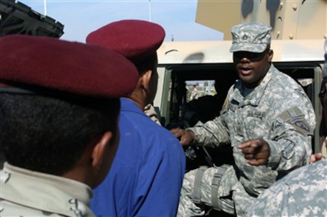 U.S. Army Staff Sgt. Mark Williams instructs Iraqi army soldiers from the 8th Iraqi Army Division during a preventative maintenance checks and services class on Feb. 21, 2007, near Ad Diwaniyah, Iraq.  