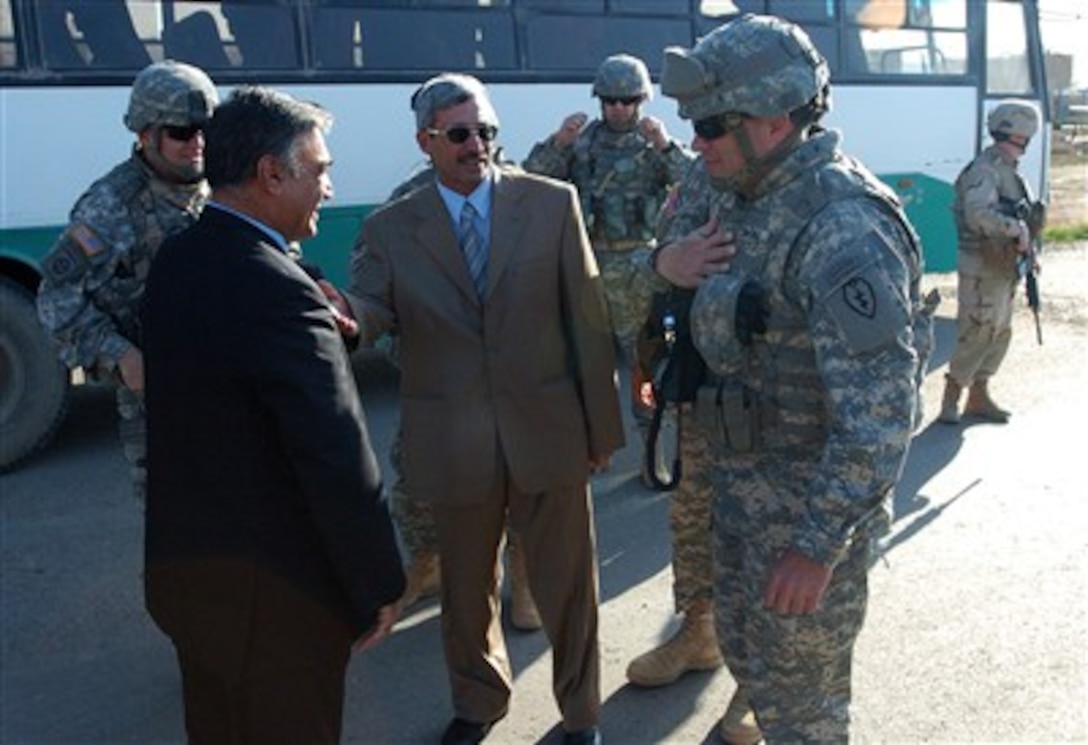 U.S Army Brig. Gen. Frank Wiercinski, 25th Infantry Division  and Salah Ad Din, Deputy Governor of Abdulla  exchange greetings with the Director of the Bayji Fertiliizer plant, March 6, 2007. 
