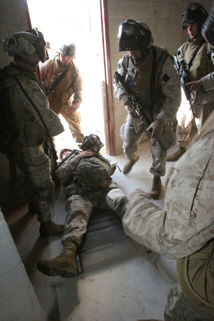 Private First Class Lantz W. Atkins, a Greenville, SC, native lays motionless as a "casualty" while his fellow Marines rush to provide him aid within a Casualty Collection Point during a raid training exercise aboard Camp Lejeune, NC, Mar. 6, 2007.  The Marines and sailors of Co. I will serve as the helicopter-borne assault company of BLT 3/8 and are scheduled to deploy as the Ground Combat Element for the 22d Marine Expeditionary Unit later this year.  (U.S. Marine Corps photo by Cpl. Peter R. Miller)