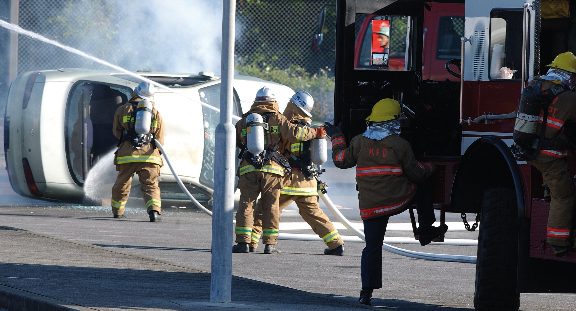 Kadena Air Base and Okinawan firefighters put out a fire on a simulated aircraft accident site at the first bilateral off-base exercise Feb. 28, 2007, between Kadena Air Base emergency responders and local Okinawan police, fire and medical teams.  The exercise was conducted to enhance cooperation between base and off-base agencies in the event of an aircraft accident.