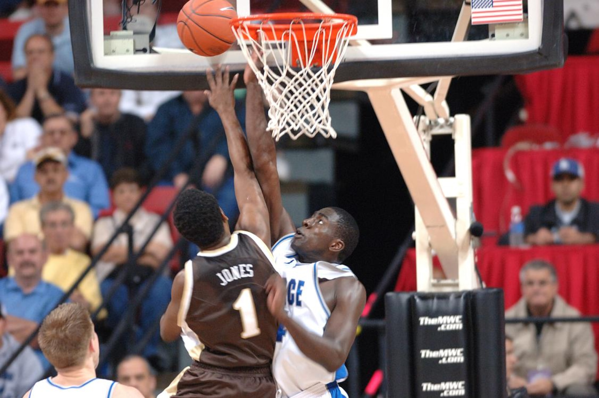 Air Force forward Dan Nwaelele fouls Wyoming guard Brad Jones as he attemps a lay up in their quarterfinal game at the Mountain West Conference tournament in Las Vegas Thursday, March 8. Nationally ranked nearly the entire season, the Falcons were eliminated in their first game of the tourney, 67-62. Air Force now has an all-time record of 0-8 in the MWC tournament. (U.S. Air Force photo/1Lt John Ross)