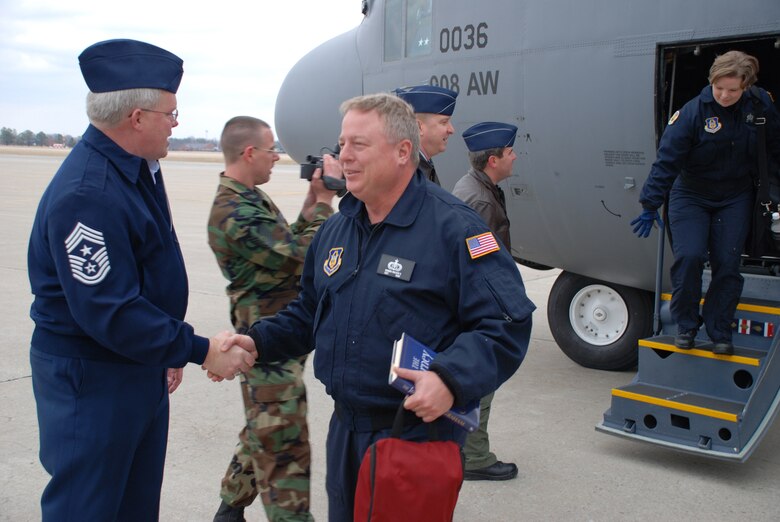 Command Chief Master Sergeant Merle Lyman welcomes the Air Force Reserve Command band from Warner Robins Air Force Base, Ga.  The band flew on a C-130 to visit the 932nd Airlift Wing and perform in the dedication ceremony on February 26.  Photo/ TSgt. Daniel Oliver