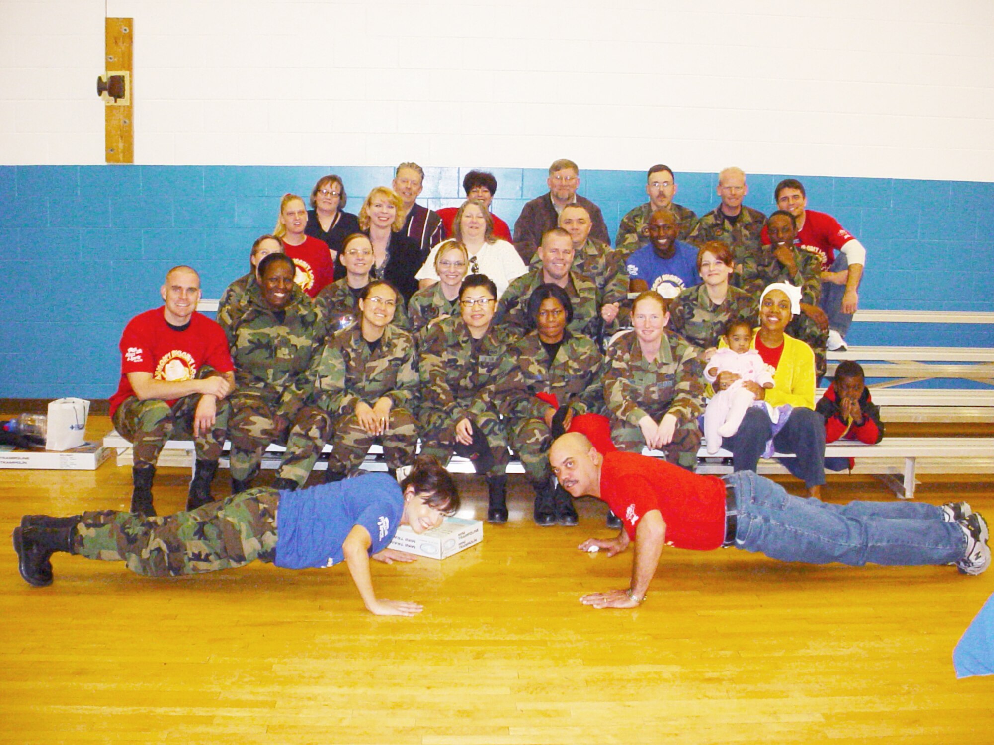 The overall winning teams pose with the faculty from the Cannon Air Force Base, N.M. Fitness Center following an awards presentation on March 2 for the Health and Wellness Center's Biggest Loser Challenge. A total of 128 participants lost 793 pounds between Jan. 16 and Feb. 23 by adapting healthier lifestyles. (U.S. Air Force photo by Yolanda Romero)                         