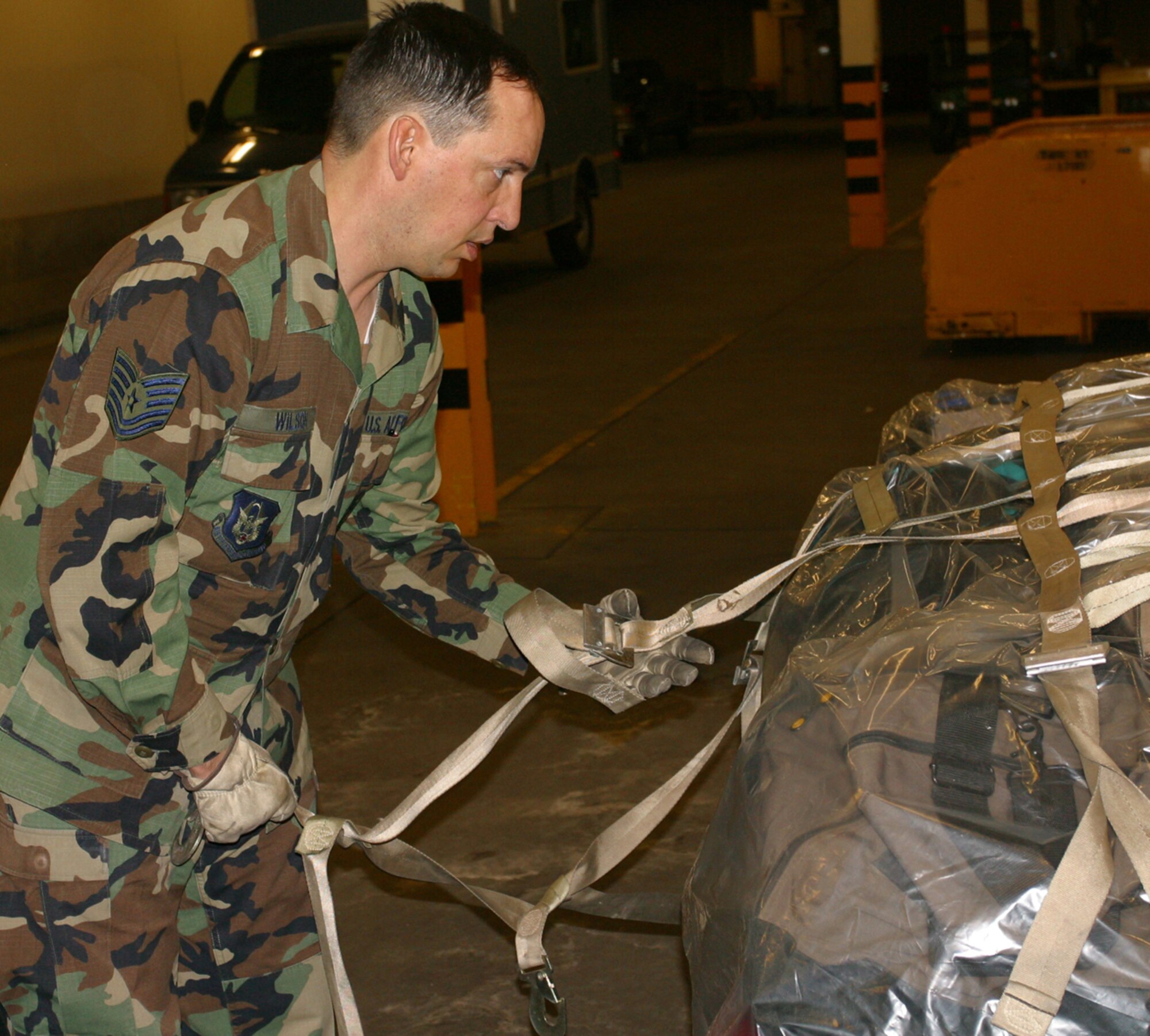 Tech. Sgt. Ken Wilson, a 67th Aerial Port Squadron passenger service team leader, readies a pallet for transport to Naval Air Station Key West, Fla., where about 250 wing personnel recently deployed for training.  (U.S. Air Force Photo by Staff Sgt. Nathan Greer)