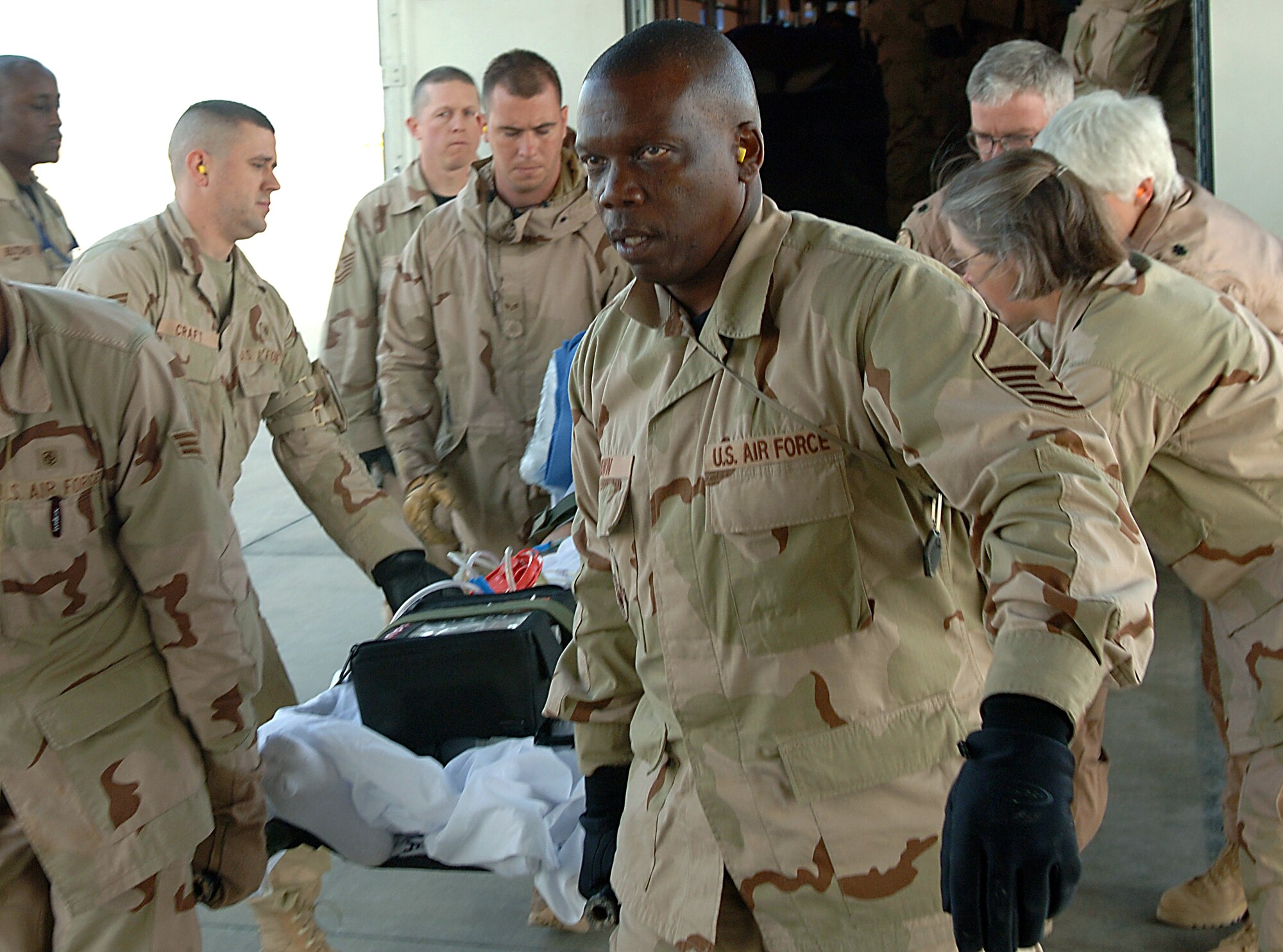 Master Sgt. James Brown helps carry a patient aboard a waiting Air Force Reserve C-17 Globemaster III for a medical evacuation flight from Balad Air Base, Iraq to Landstuhl Regional Medical Center, Germany, for further treatment. Sergeant Brown is assigned to the 332nd Expeditionary Medical Group and is from the Air Force Reserve's 920th Aeromedical Staging Squadron at Patrick Air Force Base, Fla. The Globemaster is from March Air Reserve Base, Calif. (U.S. Air Force photo/Airman 1st Class Nathan Doza)