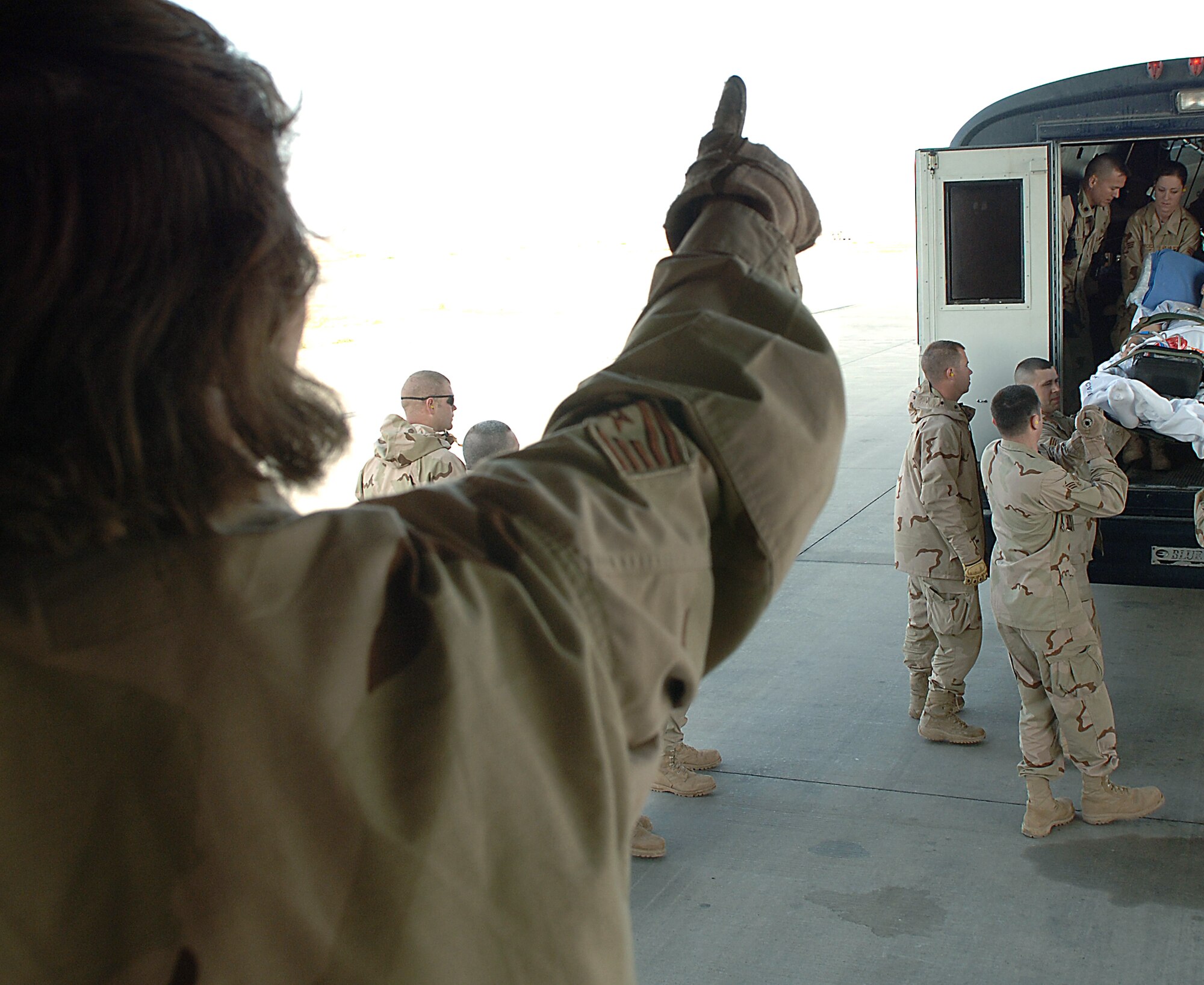 Air evacuation operations officer Tech. Sgt. Stacy Foster gives a thumbs-up to Airmen boarding a C-17 Globemaster III with an injured Soldier. This Soldier and others are being flown from Balad Air Base, Iraq to Landstuhl Regional Medical for further treatment for their injuries. Sergeant Foster is assigned to the 332nd Expeditionary Air Evacuation Flight. The Globemaster is from March Air Reserve Base, Calif. (U.S. Air Force photo/Airman 1st Class Nathan Doza) 