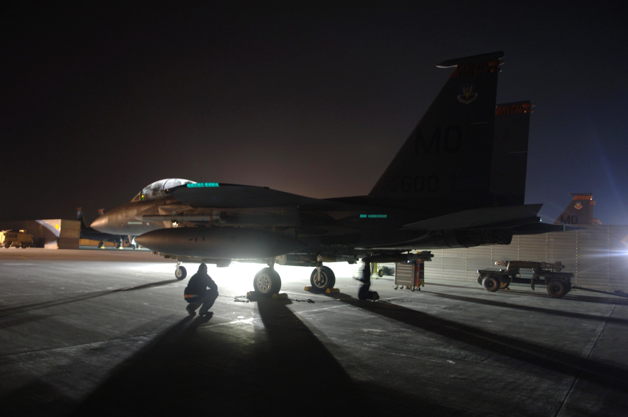 Crew chiefs make final checks on an F-15E Strike Eagle before departing for a night mission at Bagram Air Base, Afghanistan. Strike Eagles prove close-air support to coalition ground forces.  (U.S. Air Force photo/Staff Sgt. Kevin Tomko)