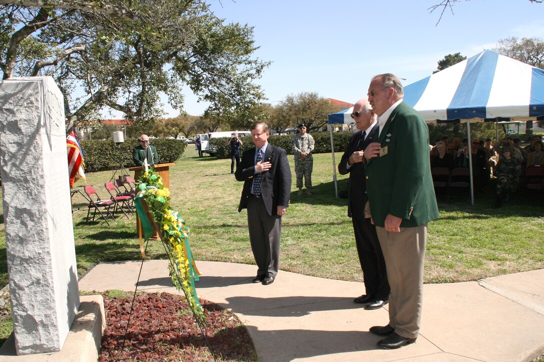 Stewart Wyland (left), Oliver R. Crawford and retired Air Force Col. Robert H. Karre place a wreath March 2 at the granite landmark at Fort Sam Houston, Texas, that commemorates the birth of military aviation.  The first military aerial flight took place here March 2, 1910.  (U.S. Army photo/Minnie Jones)