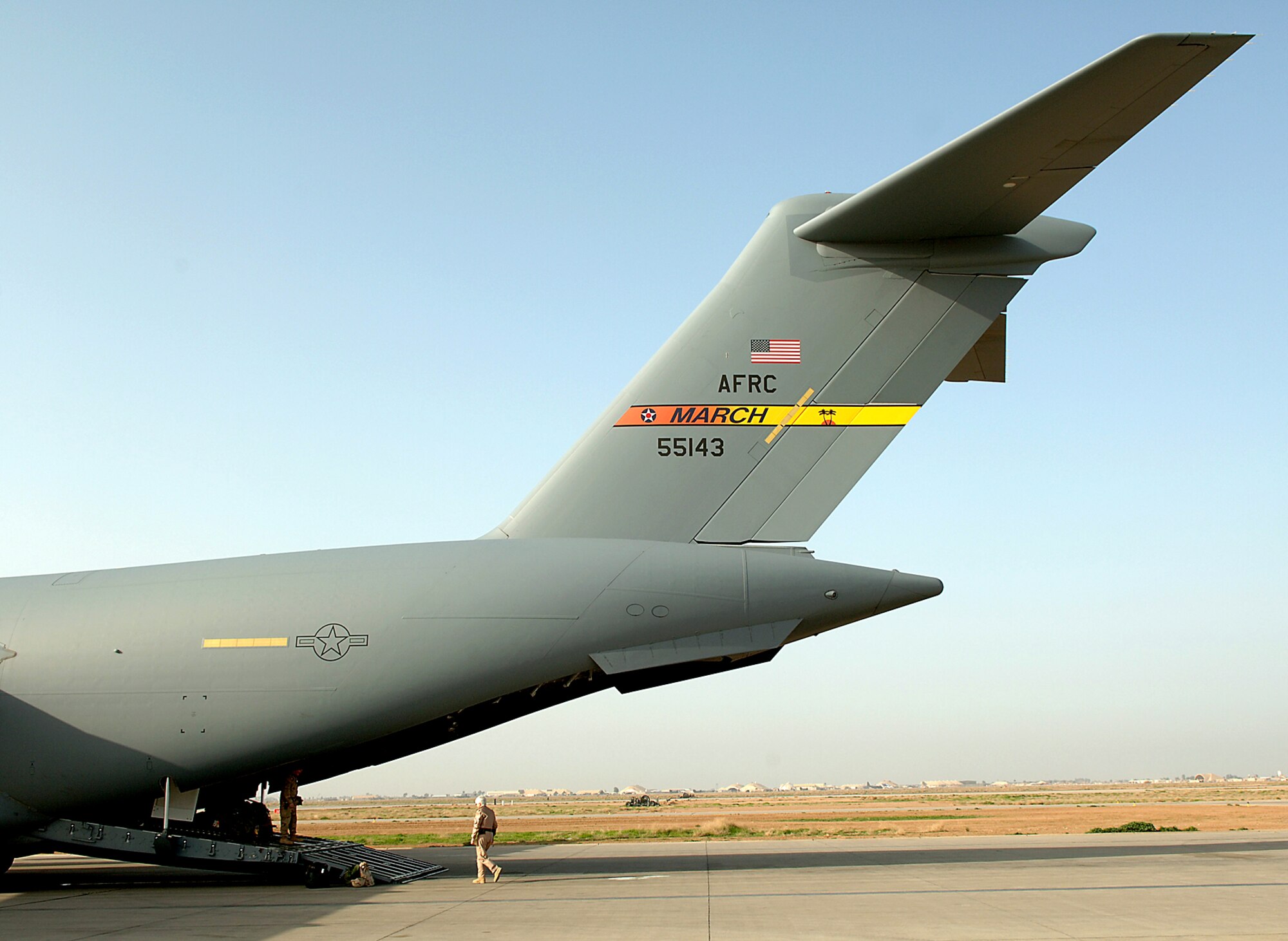 Flight surgeon Lt. Col. Nina Gilbergat is dwarfed by a C-17 Globemaster III as she prepares to walk up the ramp door before an aeromedical evacuation mission from Balad Air Base, Iraq to Landstuhl Regional Medical Center in Germany. Colonel Gilbergat is assigned to the 332nd Contingency Aeromedical Staging Flight.The Globemaster is from March Air Reserve Base, Calif. (U.S. Air Force photo/Airman 1st Class Nathan Doza) 
