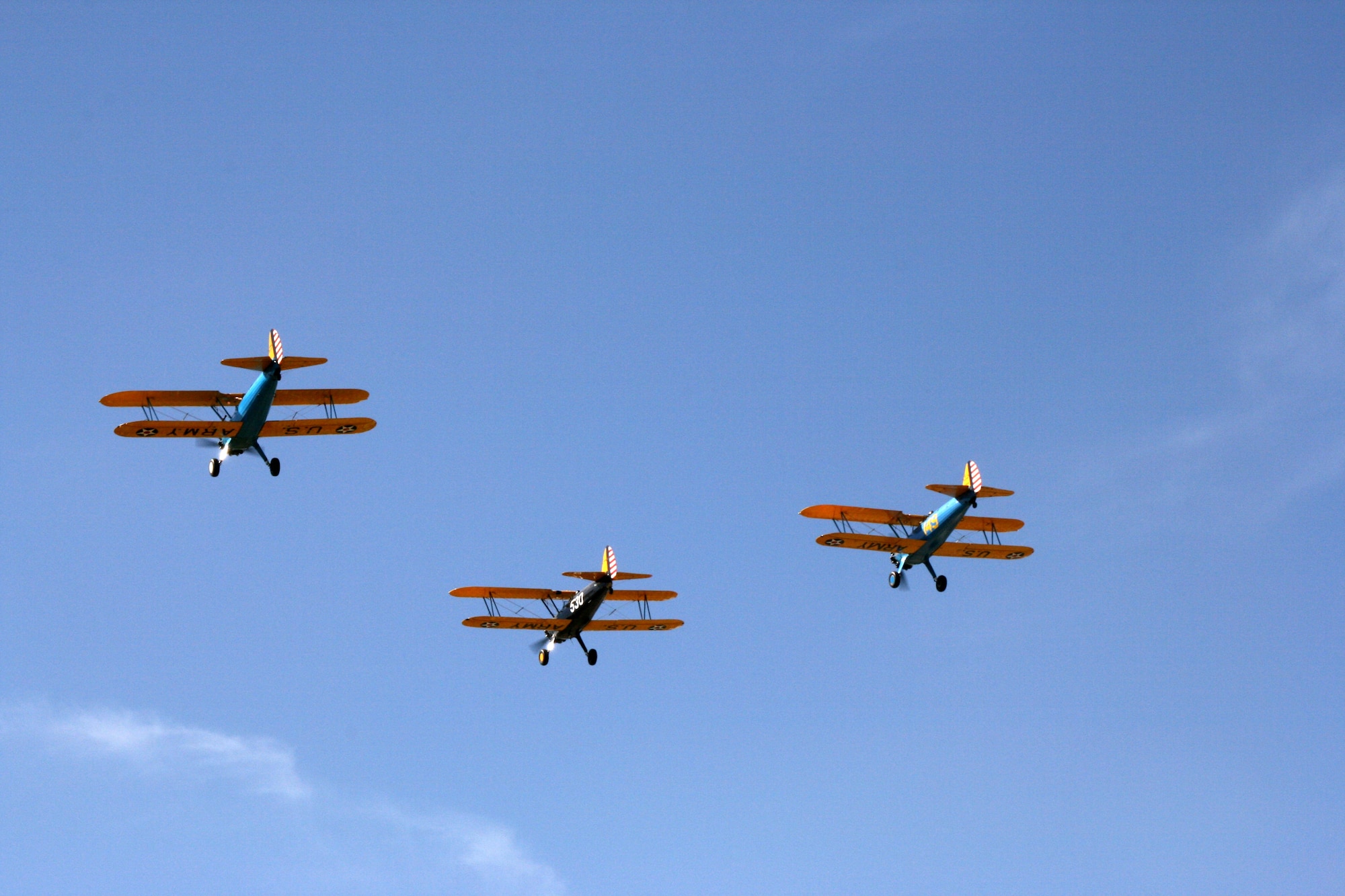 Bryan Cooke, lead, Mickey Chadwell and Jim Edell fly their vintage Stearman aircraft March 2 over the main parade ground at Ft. Sam Houston, Texas, site of the first military aerial flight 97 years ago.  The flyover was part of a commemoration held to celebrate that first flight.  (U.S. Army photo/Minnie Jones)

