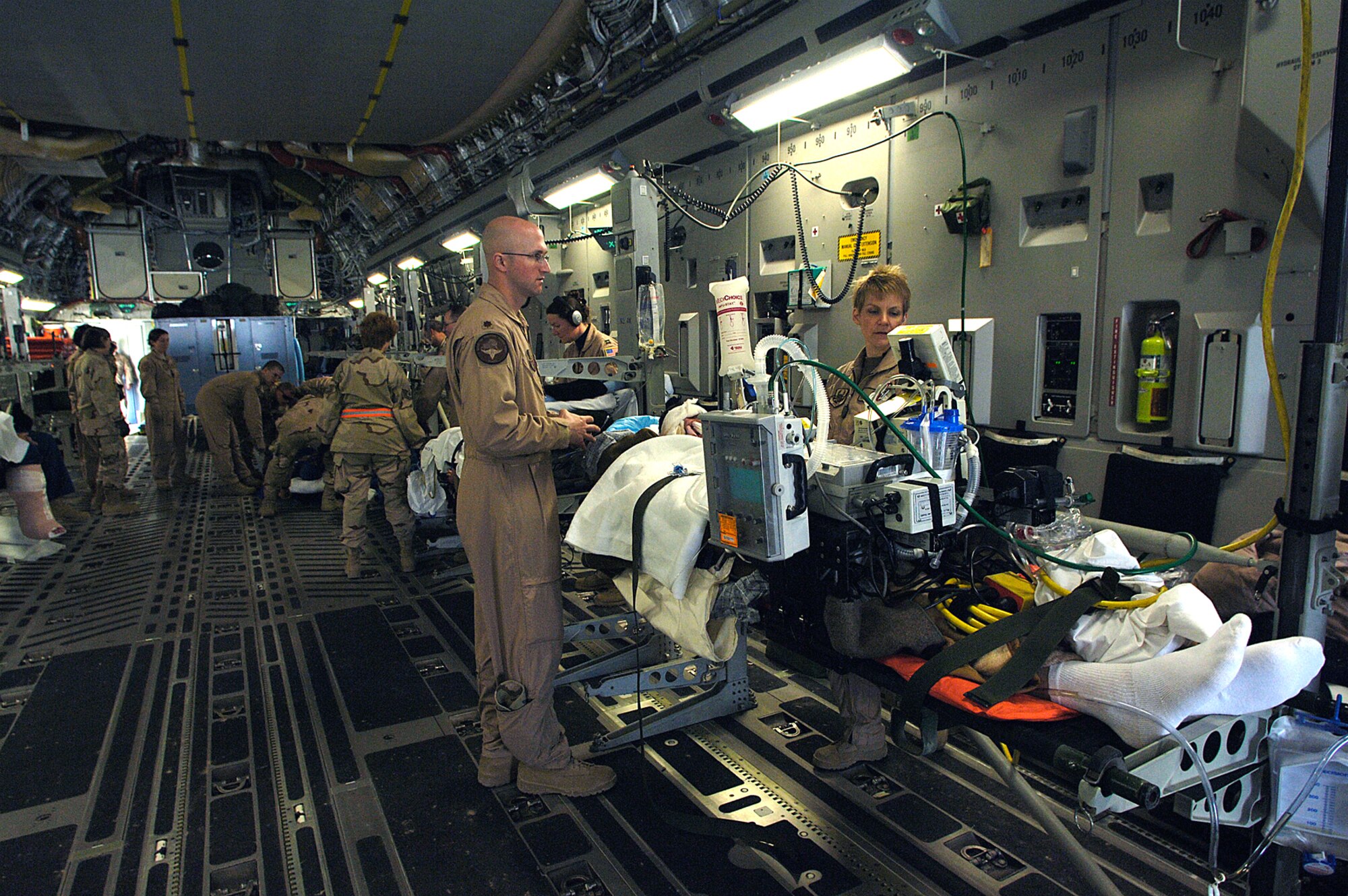 Airmen of the 332nd Expeditionary Medical Group care for patients aboard a waiting Air Force Reserve C-17 Globemaster III for a medical evacuation flight to Landstuhl Regional Medical Center in Germany for further treatment. The Globemaster is from March Air Reserve Base, Calif. (U.S. Air Force photo/Airman 1st Class Nathan Doza) 
