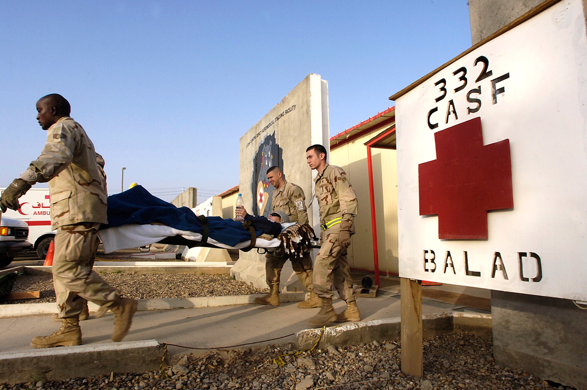 Airmen of the 332nd Expeditionary Medical Group carry a patient from the Contingency Aeromedical Staging Facility at Balad Air Base, Iraq, for transport to a waiting Air Force Reserve C-17 Globemaster III for a medical evacuation flight to Landstuhl Regional Medical Center in Germany. The Globmaster is from March Air Reserve Base, Calif.(U.S. Air Force photo/Airman 1st Class Nathan Doza) 
