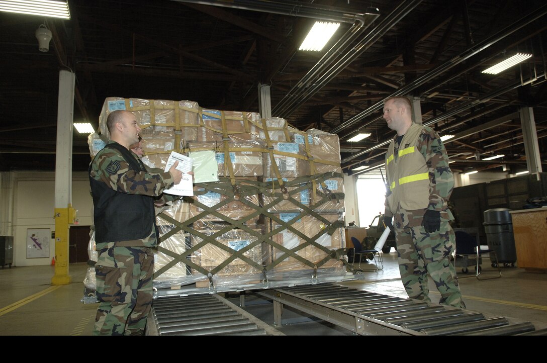 28th Bomb Wing Cargo Deployment Function team members check cargo at Ellsworth Air Force Base, S.D., March 5. Ellsworth conducted Badlands Express Phase 1 Operational Readiness Exercise 07-03 March 2 through March 7 in preparation for an operational readiness inspection in November. Ellsworth Airmen processed 272 tons of cargo and 451 passengers during the exercise. (U.S. Air Force photo/Staff Sgt. Michael B. Keller)