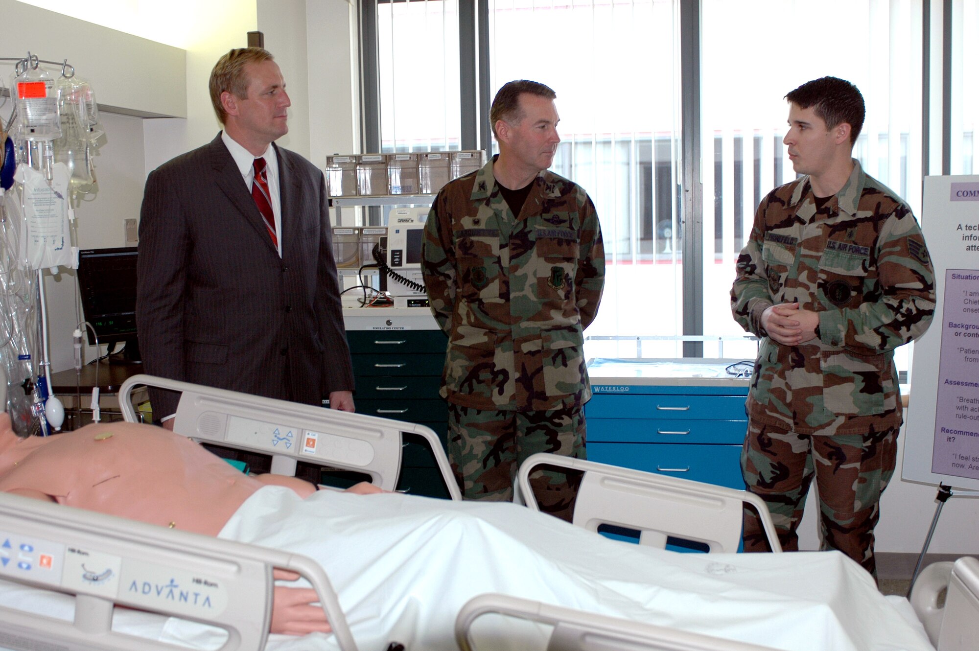 Staff Sgt. Ivan Fronefield explains to California State Senator Jeff Denham (R-Merced) and Col. Steve Arquiette, 60th Air Mobility Wing commander, why standardization is a vital training tool for the David Grant USAF Medical Center medical staff at Travis Air Force Base, Calif. The senator came March 1 to present California Senate Concurrent Resolution 122, which recognizes DGMC as an important segment of America's Armed Forces and for the contributions they have made to world peace, America's freedom and the way of life enjoyed by the people of the state of California. Sergeant Fronefield is a Sim Center technician for the 60th Medical Operations Squadron. (U.S. Air Force photo by Staff Sgt. Candy Knight) 