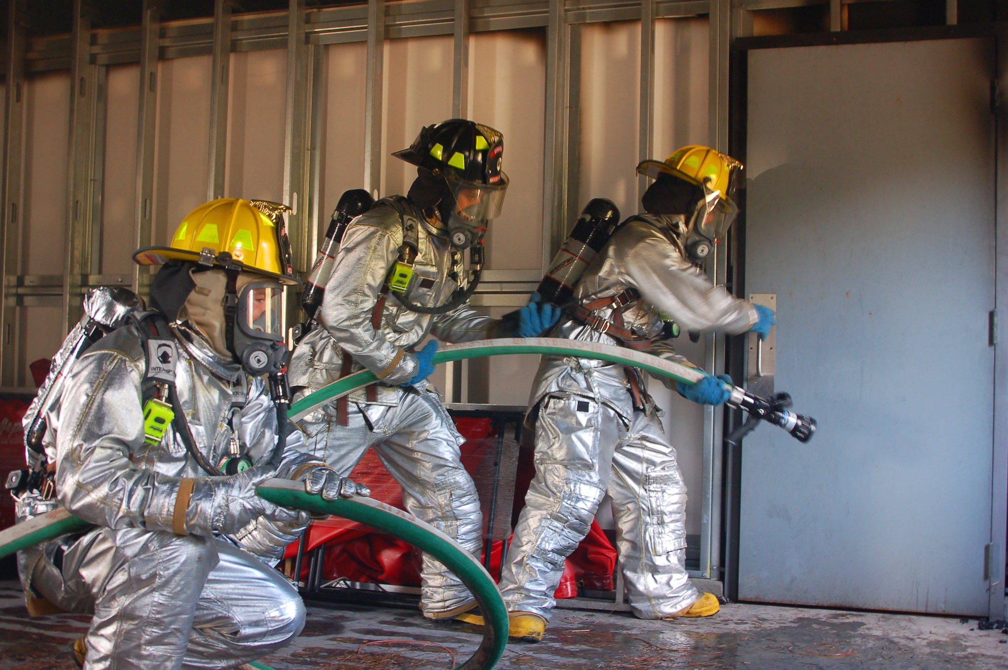 MOODY AIR FORCE BASE, Ga. --  Members of the 23rd Civil Engineer Squadron Fire and Emergency Services Flight prepare to enter a burning room during structural fire training March 3, at the base Fire Training Pit area.  (U.S. Air Force photo by Tech. Sgt. Parker Gyokeres)