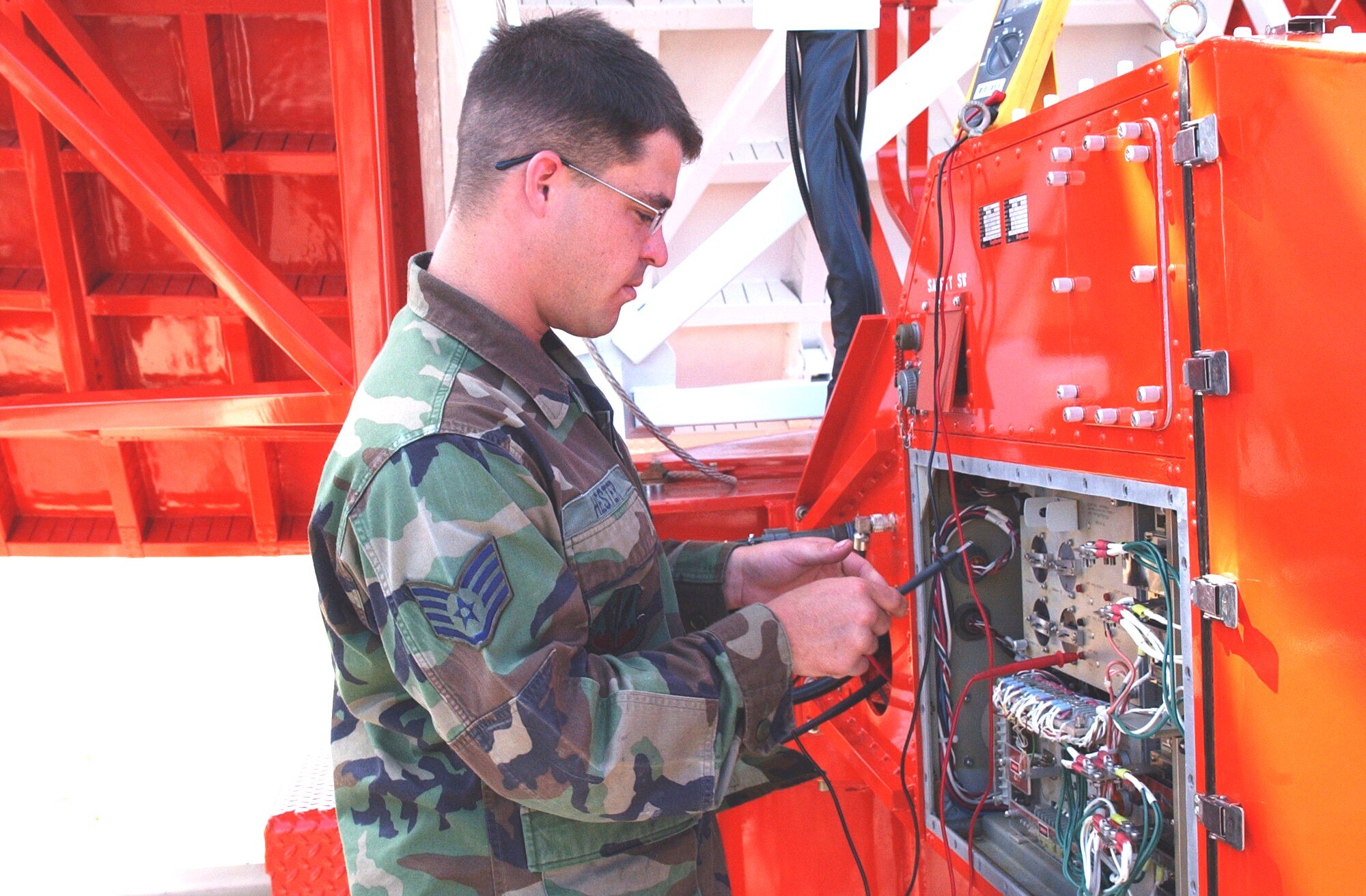 SOTO CANO AIR BASE, Honduras – Staff Sgt. Donald Hester, 612th Air Base Squadron, lines up the ground position navigation radar antenna assembly with the reference reflector at the end of the runway.  The Army/Navy GPN 22 provides precision guidance for aircraft within 20 miles of the base.  (U.S. Air Force photo/Tech. Sgt. Sonny Cohrs)

