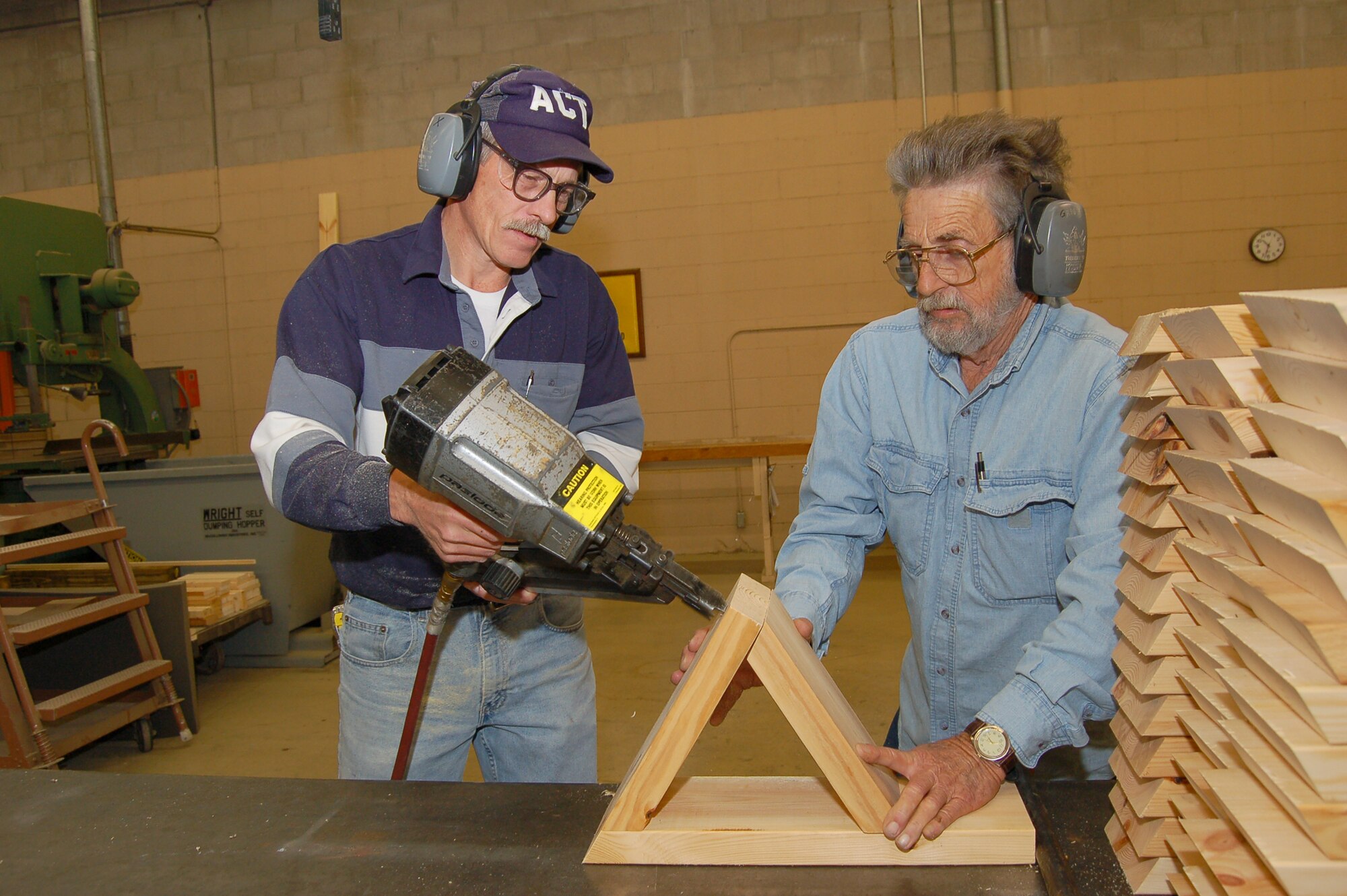 MOODY AIR FORCE BASE, Ga. -- Ken Lamoreaux and Grady Green, 23rd Logistics Readiness Squadron packing and crating section carpenters, build wooden chocks for shipping vehicles on flatbed trucks March 5.  The section custom-builds packing crates, braces and custom wooden assemblies to protect large or oddly-shaped cargo during transport.  Every piece of wood used must be accounted for and verified as heat-treated, a program the recent Logistics Standarization Evaluation Team noted for its excellence.  
  (U.S. Air Force photo by Tech. Sgt. Parker Gyokeres)
