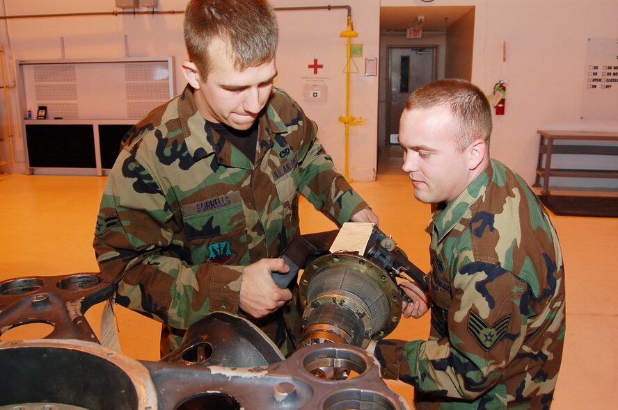 MOODY AIR FORCE BASE, Ga. -- Airman 1st Class Jeremy Sorrells and Staff Sgt. Darel Shelton, both 723rd Maintenance Squadron HH-60G Pave Hawk crew chiefs, install a main rotor blade spindle into a hub assembly at the HH-60G phase dock March 5. The section’s process improvements were recognized by the recent visit of the Logistics Standardization Evaluation Team.  (U.S. Air Force photo by Tech. Sgt. Parker Gyokeres)