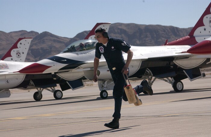 3/6/2007 - NELLIS AIR FORCE BASE, Nev. -- Staff Sergeant Gavin Douglas, a dedicated crew chief for the #2 jet assigned to the United States Air Force Air Demonstration Squadron, removes chalks from his aircraft during the team's show launch.
(U.S. Air Force Photo by Senior Airman Larry E. Reid Jr.)