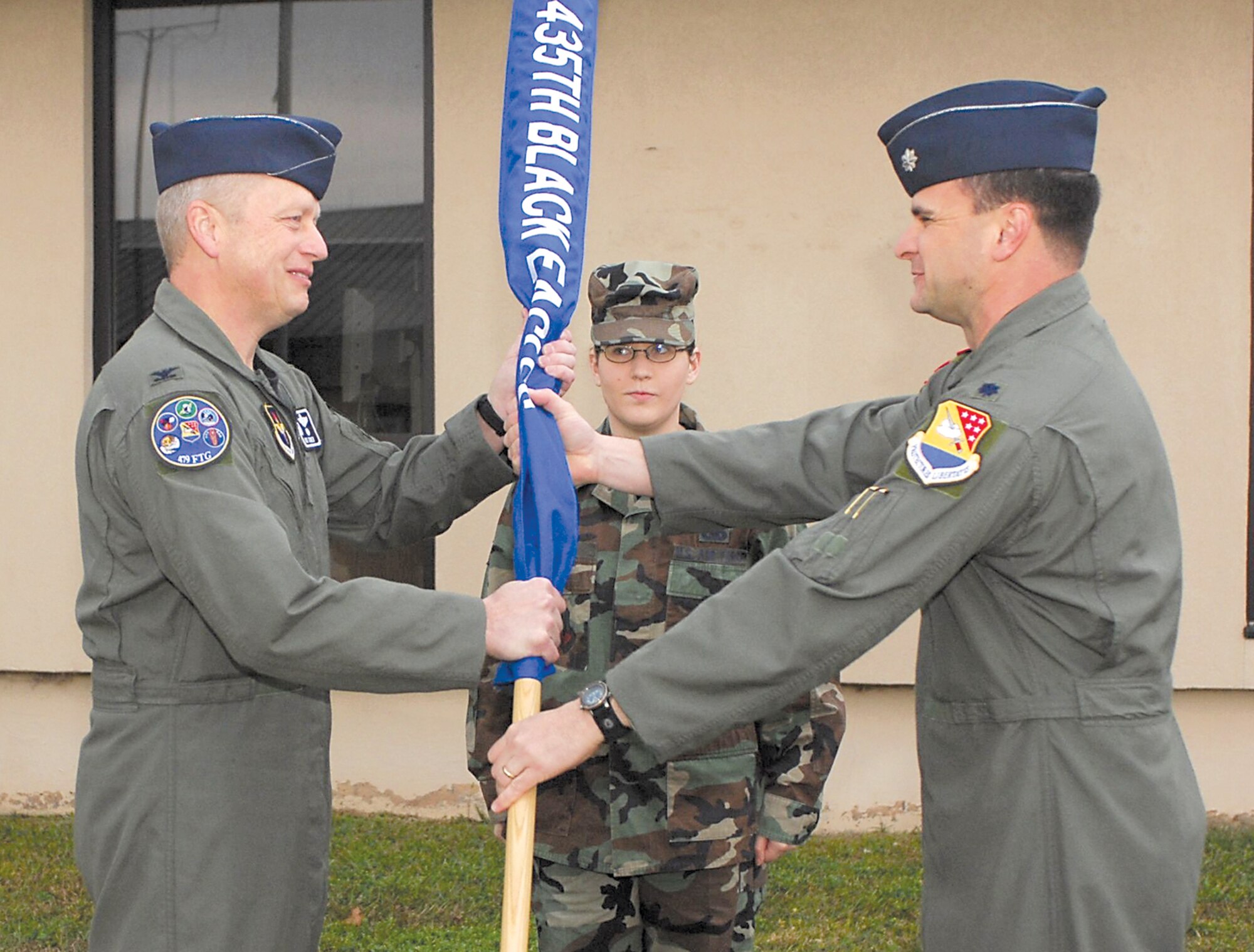 MOODY AIR FORCE BASE, Ga. -- Col. Richard Turner, 479th Flying Training Group commander, passes the 435th Flying Training Squadron guidon to Lt. Col. Robert Sweet, 435th Flying Training Squadron commander, here at the 435th FTS relocation ceremony March 1. The 435th FTS is in the process of relocating from Moody to Randolph Air Force Base, Texas. (U.S. Air Force photo by Senior Airman Angelita Lawrence)