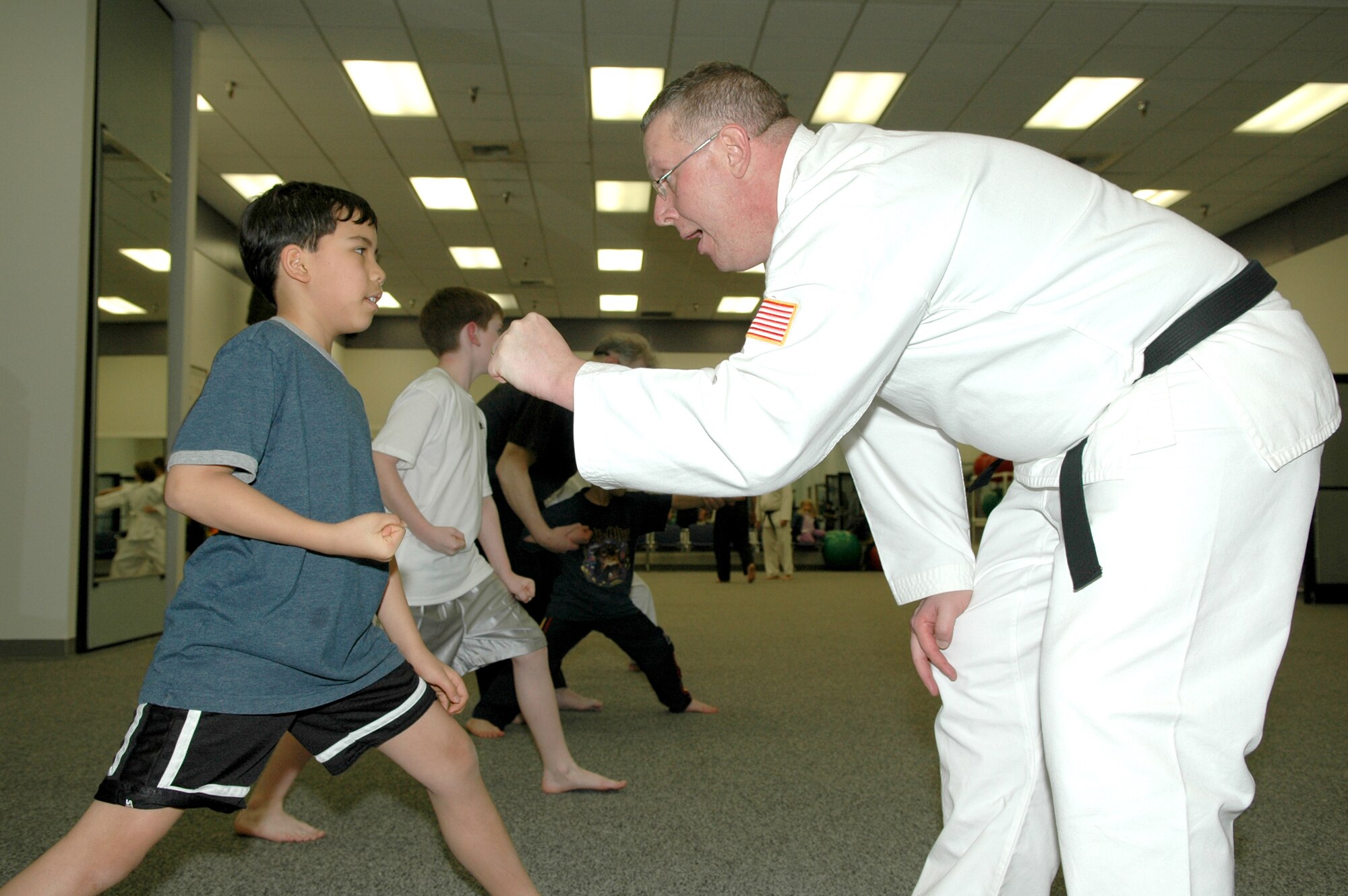 FAIRCHILD AIR FORCE BASE, Wash. -- Daniel Lovelace, son of Dawn Nickerson, who works at the Fairchild Commissary, receives guidance from instructor David Brown, 92nd Contracting Squadron Monday at a Shotokan Karate class. The class focuses on self-discipline, self-defense and self-motivation. (Photo by Staff Sgt. Kristian Carter)
