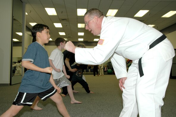 FAIRCHILD AIR FORCE BASE, Wash. -- Daniel Lovelace, son of Dawn Nickerson, who works at the Fairchild Commissary, receives guidance from instructor David Brown, 92nd Contracting Squadron Monday at a Shotokan Karate class. The class focuses on self-discipline, self-defense and self-motivation. (Photo by Staff Sgt. Kristian Carter)
