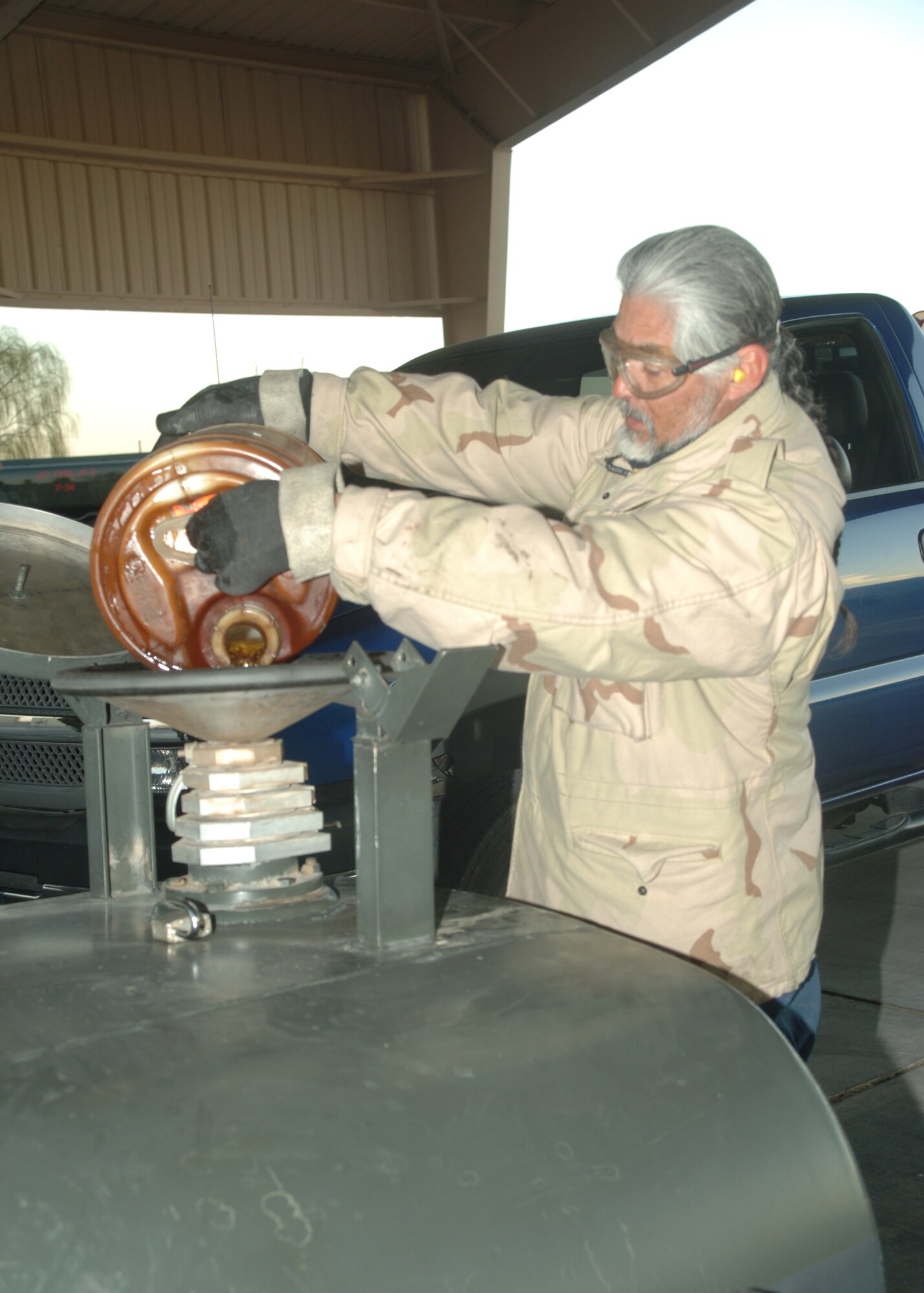 Mr. Dale Travis, 49th Logistics Readiness Squadron Petroleum, Oils and Lubricants Flight, pours fuel into a tank. The fuel is stored in a tank until it is deemed safe for re-use. (United States Air Force photo by Airman 1st Class Tiffany Mayo)