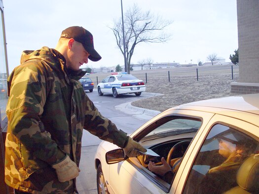 Staff Sgt. Tim Ransom, a 22nd Civil Engineer Squadron member serving as a 22nd Security Forces augmentee, hands out Eagle Eyes pamphlets March 1 while checking identification cards at McConnell’s main gate. Eagle Eyes is an Air force-wide defensive program geared toward teaching people to detect and deter terrorism. The program educates people on the planning activities associated with terrorist acts. It is also designed to encourage people to notify authorities when they see something suspicious. To schedule an Eagle Eyes briefing at McConnell, call 759-4124. To report suspicious activities, call local law enforcement authorities or the McConnell law enforcement desk at 759-3976. (Air Force photo by Senior Airman Amanda Currier)                               