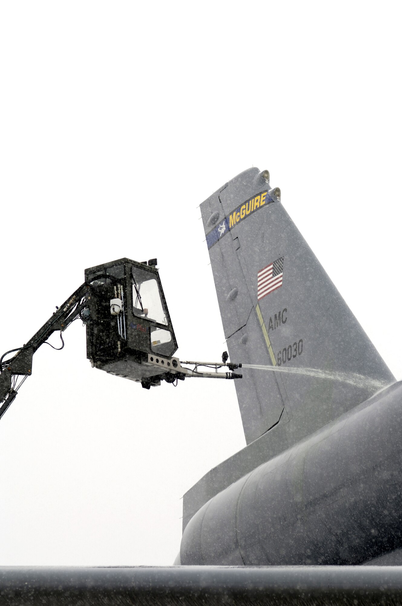 A KC-10A Extender is deiced March 7 by a member of the 605th Aircraft Maintenance Squadron at McGuire Air Force Base, N.J. during a snow storm that hit the base. (U.S. Air Force photo/Kenn Mann.