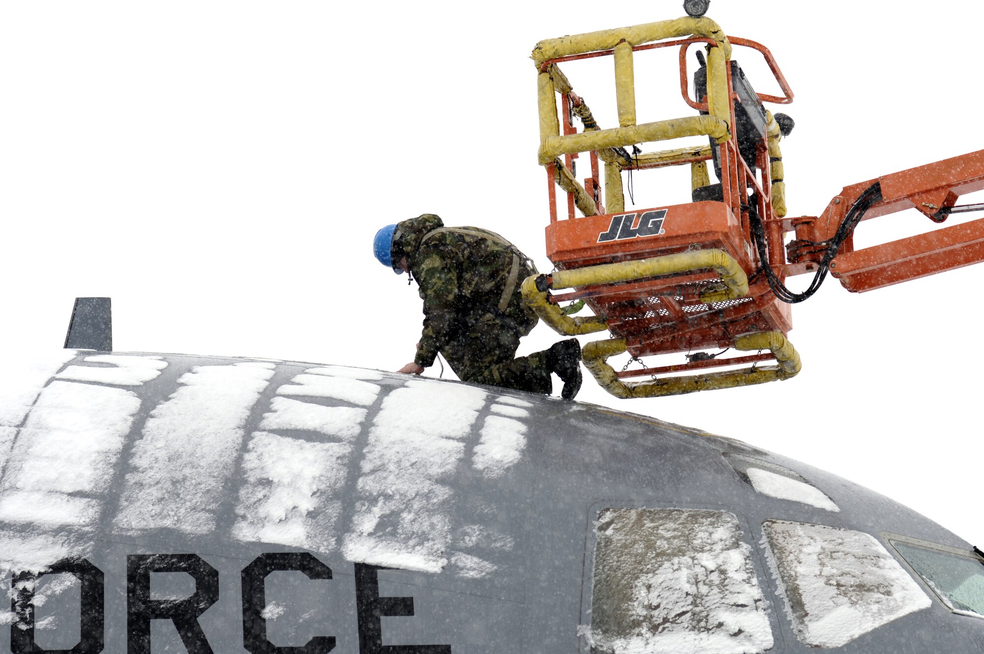 Airman Russell Baker, a fuel systems journeyman, works on the air-refueling receptacle of a C-17 Globemaster III March 7 during a snowstorm that hit McGuire Air Force Base, N.J. Airman Baker is assigned the 305th Maintenance Squadron. (U.S. Air Force photo/Kenn Mann)